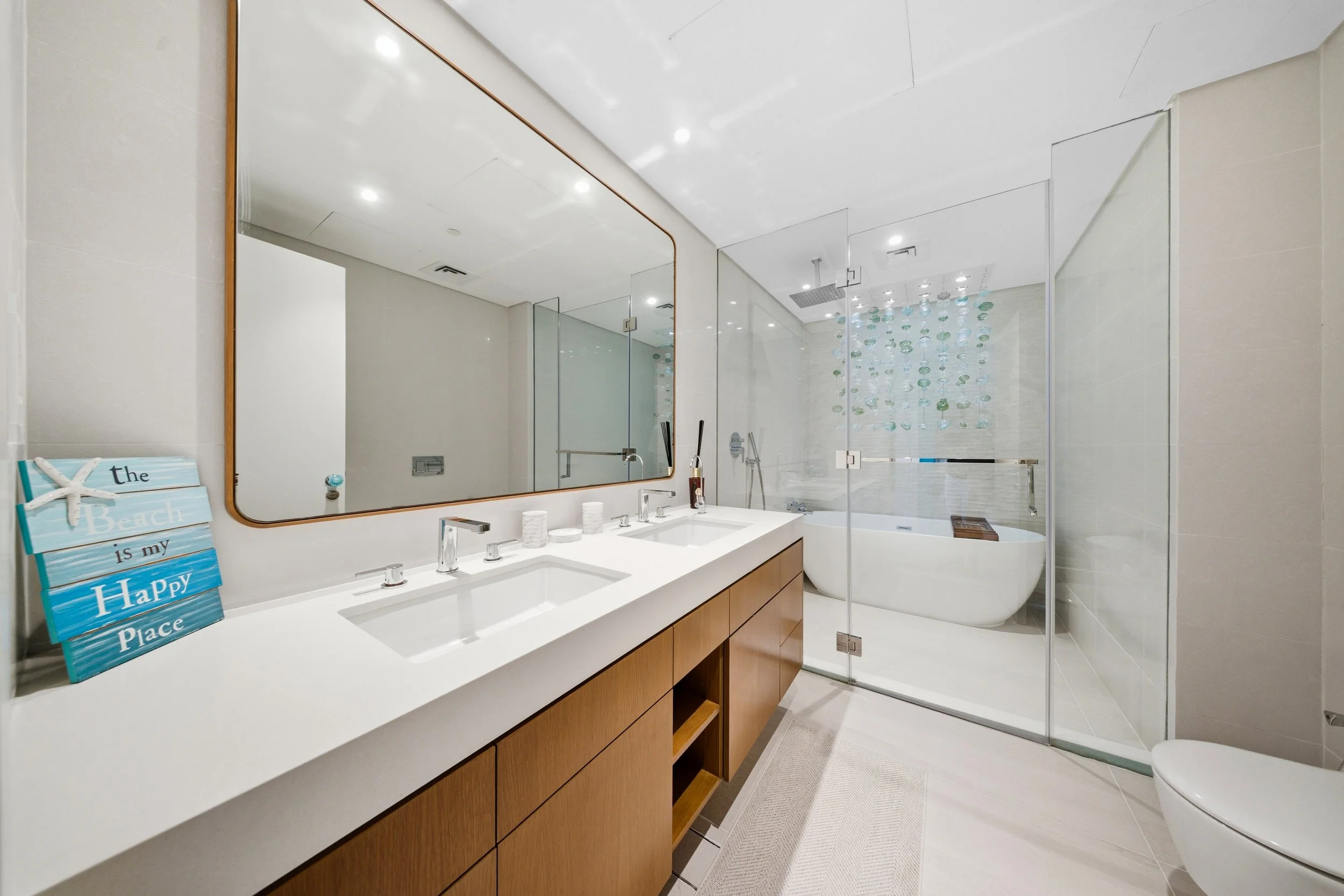 Spacious bathroom with double vanity, walk-in shower and freestanding bathtub.