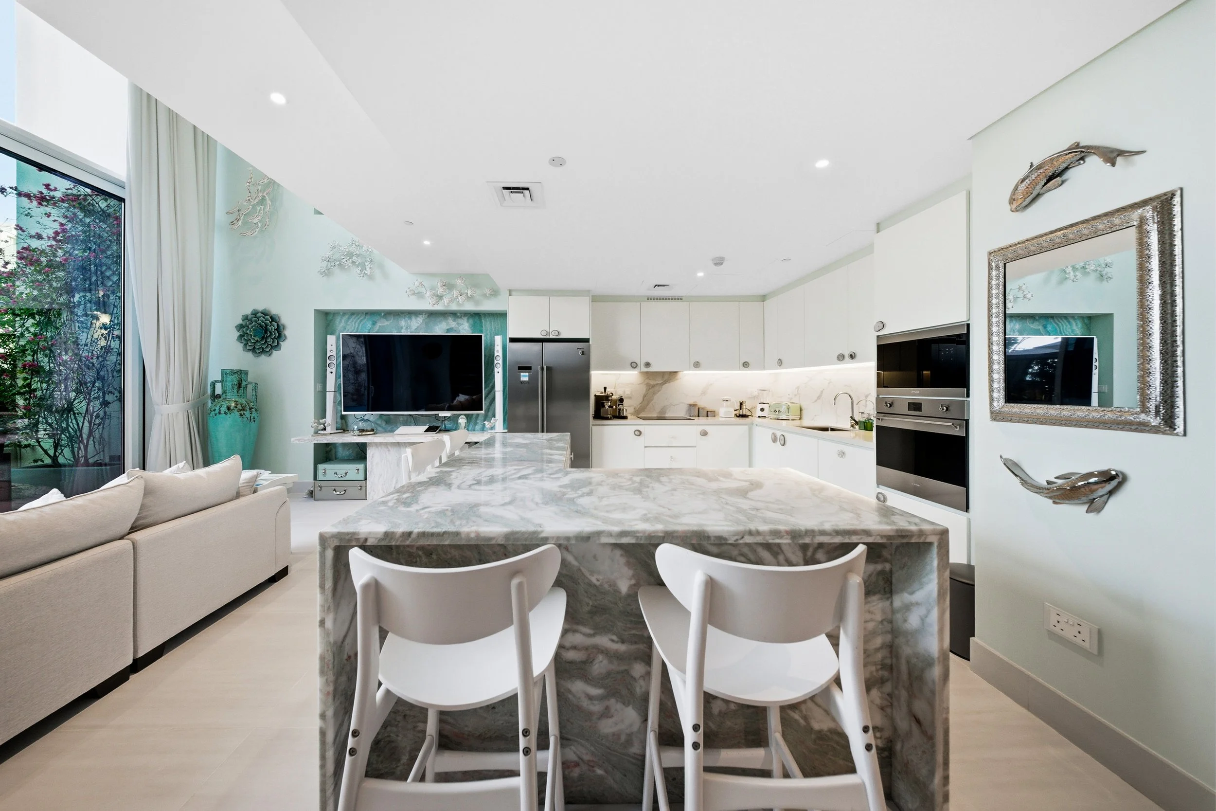 Fully equipped modern kitchen with marble island seating.