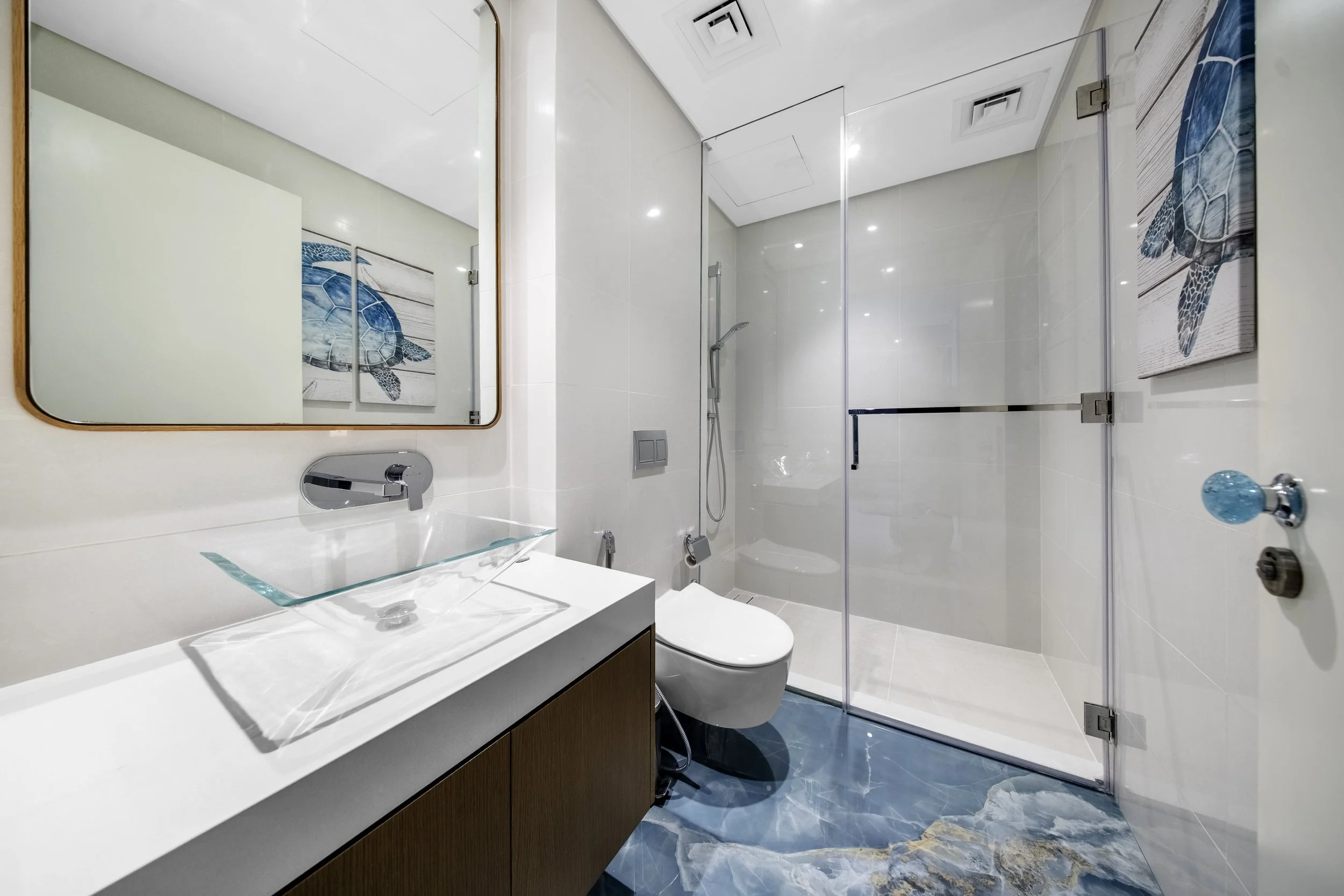 Fresh, modern bathroom with walk-in shower and coastal styling.