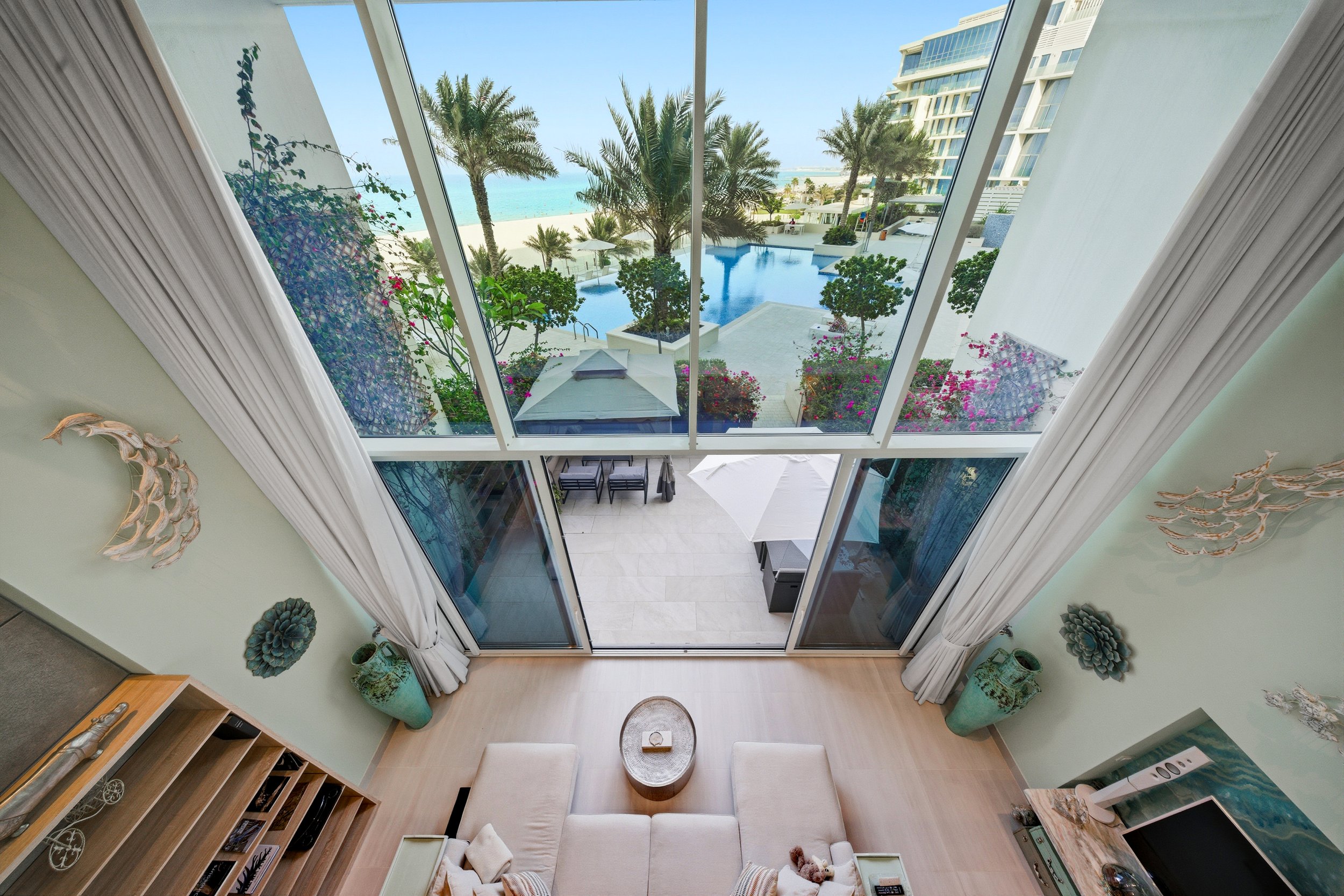 Expansive open-plan lounge with soaring ceilings and seamless indoor–outdoor flow.