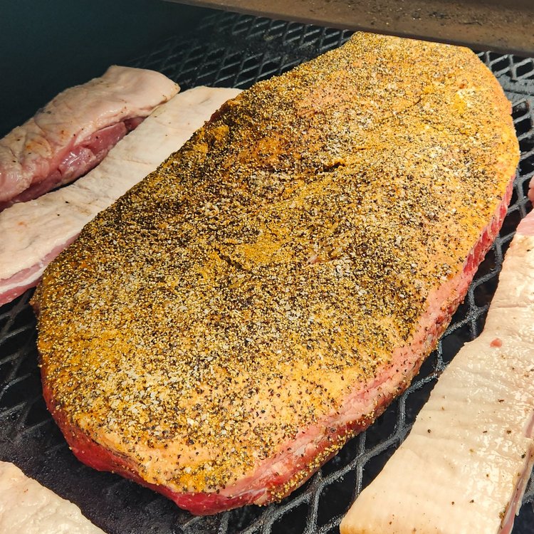 A whole brisket, seasoned and going onto the pit