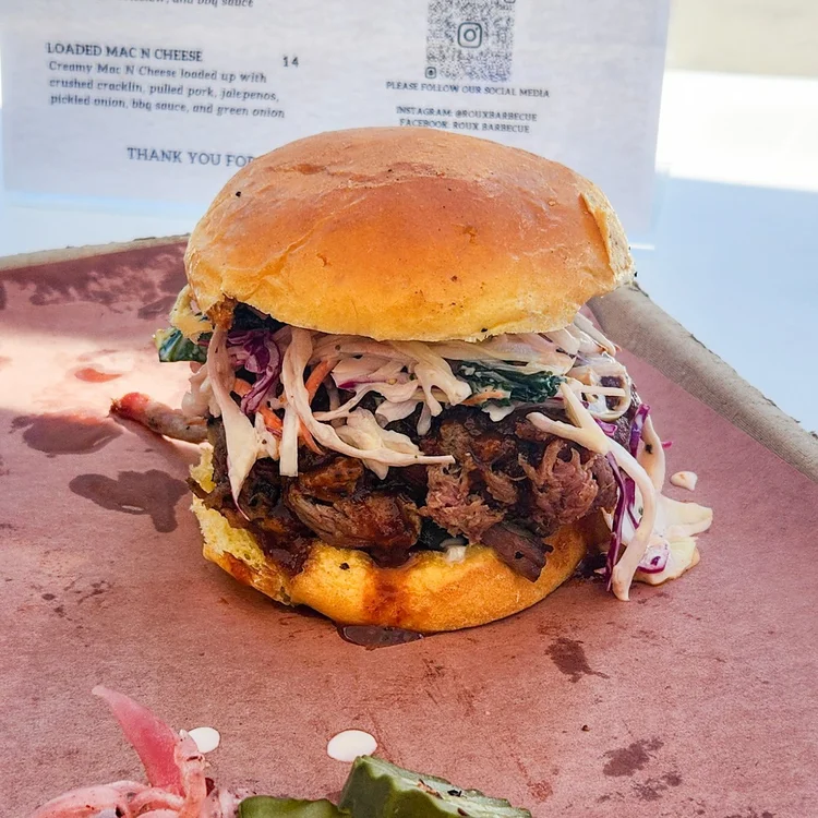 Pulled pork sandwich stacked high with slaw