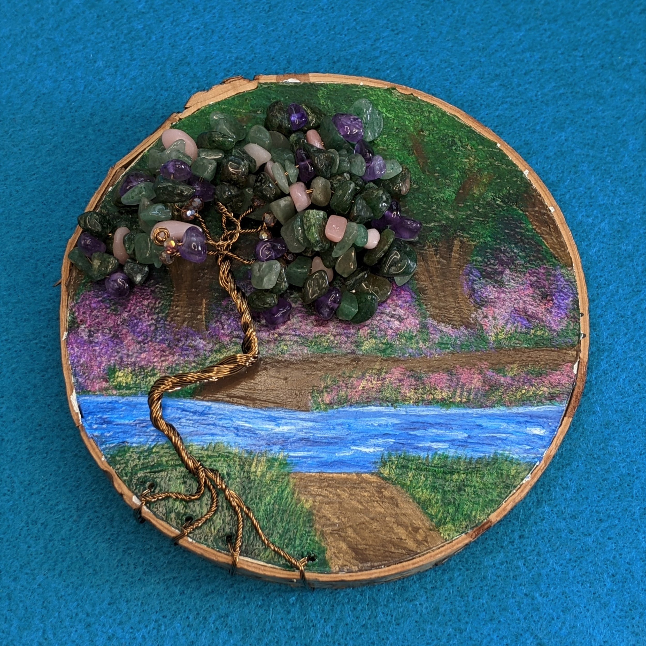 Painting of a wooded scene and river on wood slice, with wire and gemstone tree