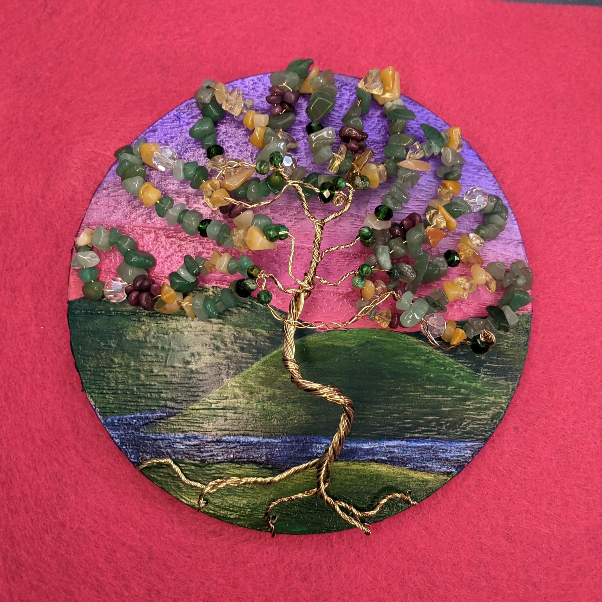 Painting of a sunset on wood slice, with wire and gemstone beaded tree