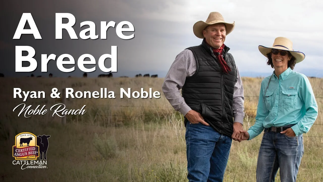 Two people in cowboy hats and outdoor clothing smiling and shaking hands in a grassy field, with text that reads "A Rare Breed Ryan & Ronella Noble Noble Ranch" and a logo for Certified Angus Beef.