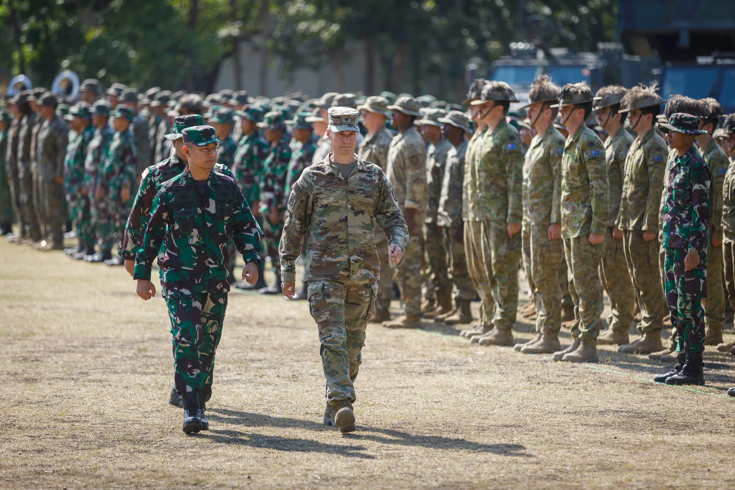 Military personnel in uniform standing in formation during a ceremony outdoors.