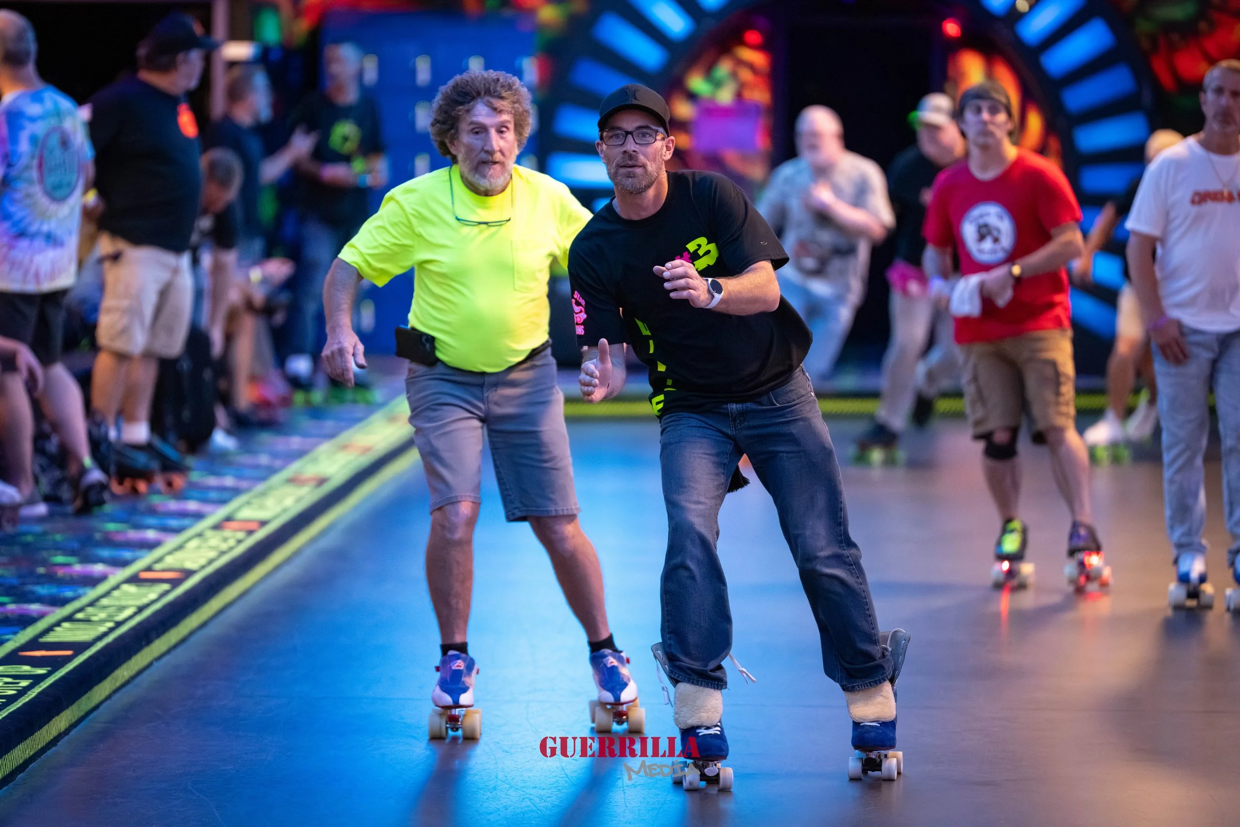 People roller skating at an indoor roller rink with colorful lights and a vibrant background.