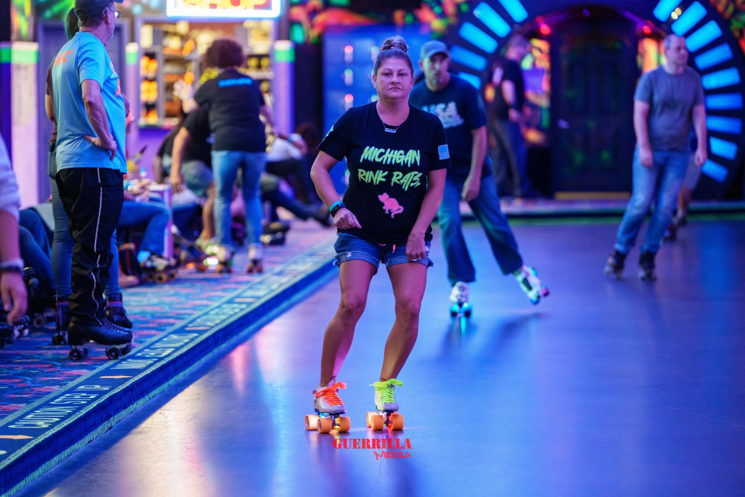 A woman roller skating inside an arcade with other skaters and onlookers around her, featuring vibrant neon lighting and a colorful background.
