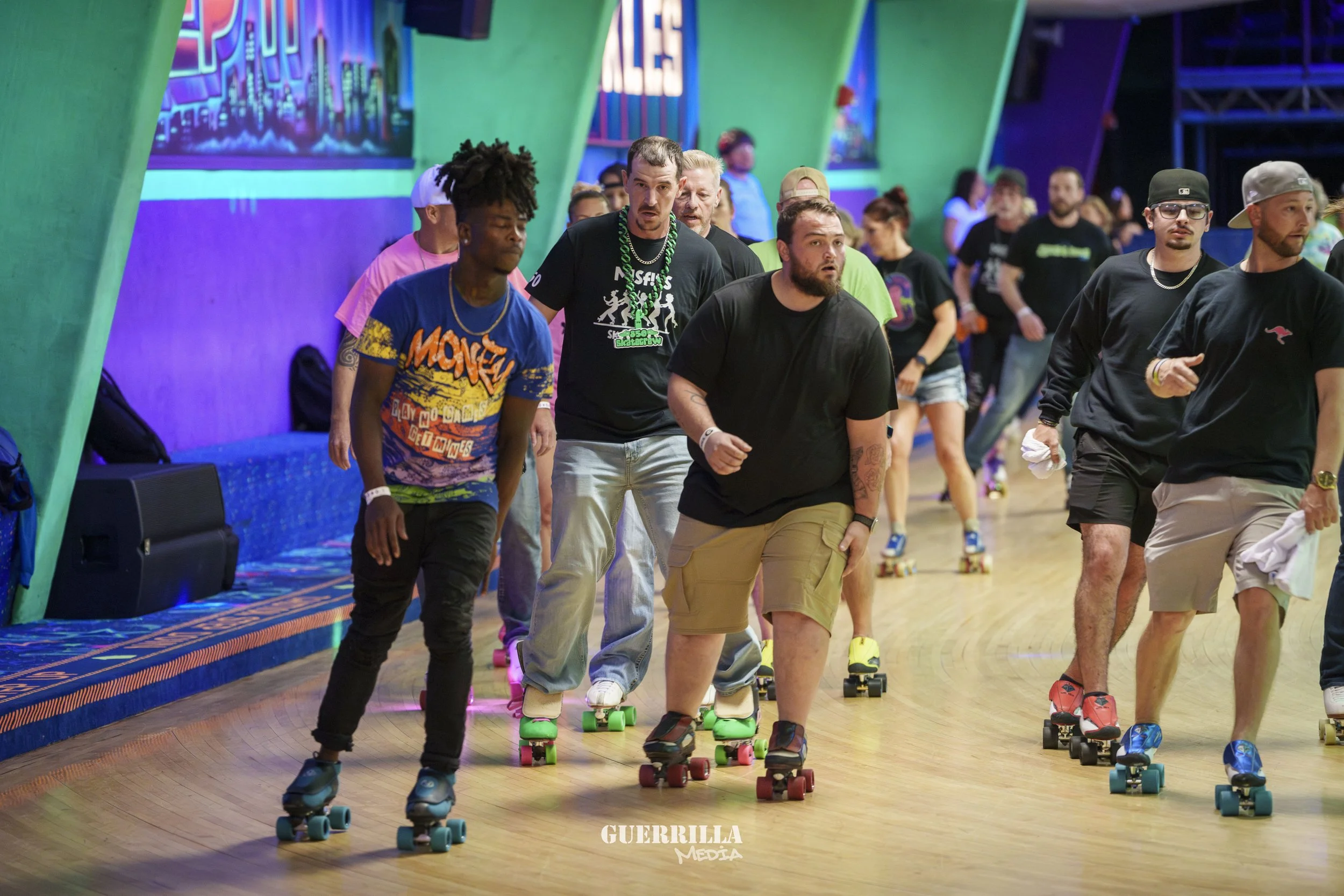 People roller skating indoors under colorful lighting, some wearing casual clothes and accessories.