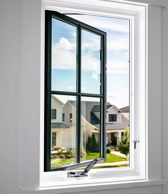 White vinyl casement window replacement with black trim and double-pane glass in a modern home, installed by Mr. Handyman of Tampa and Clearwater.