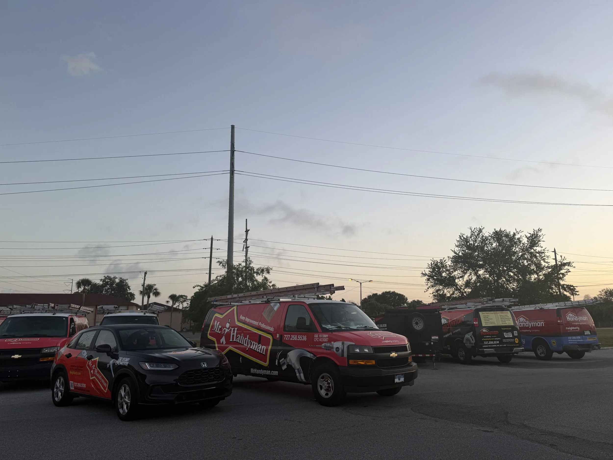 Mr. Handyman Serving Tampa Bay fleet of branded service vans and trucks parked at sunrise – providing professional home repair, maintenance, and improvement services in Citrus Park, Palm Harbor, Clearwater, Largo, and surrounding areas.