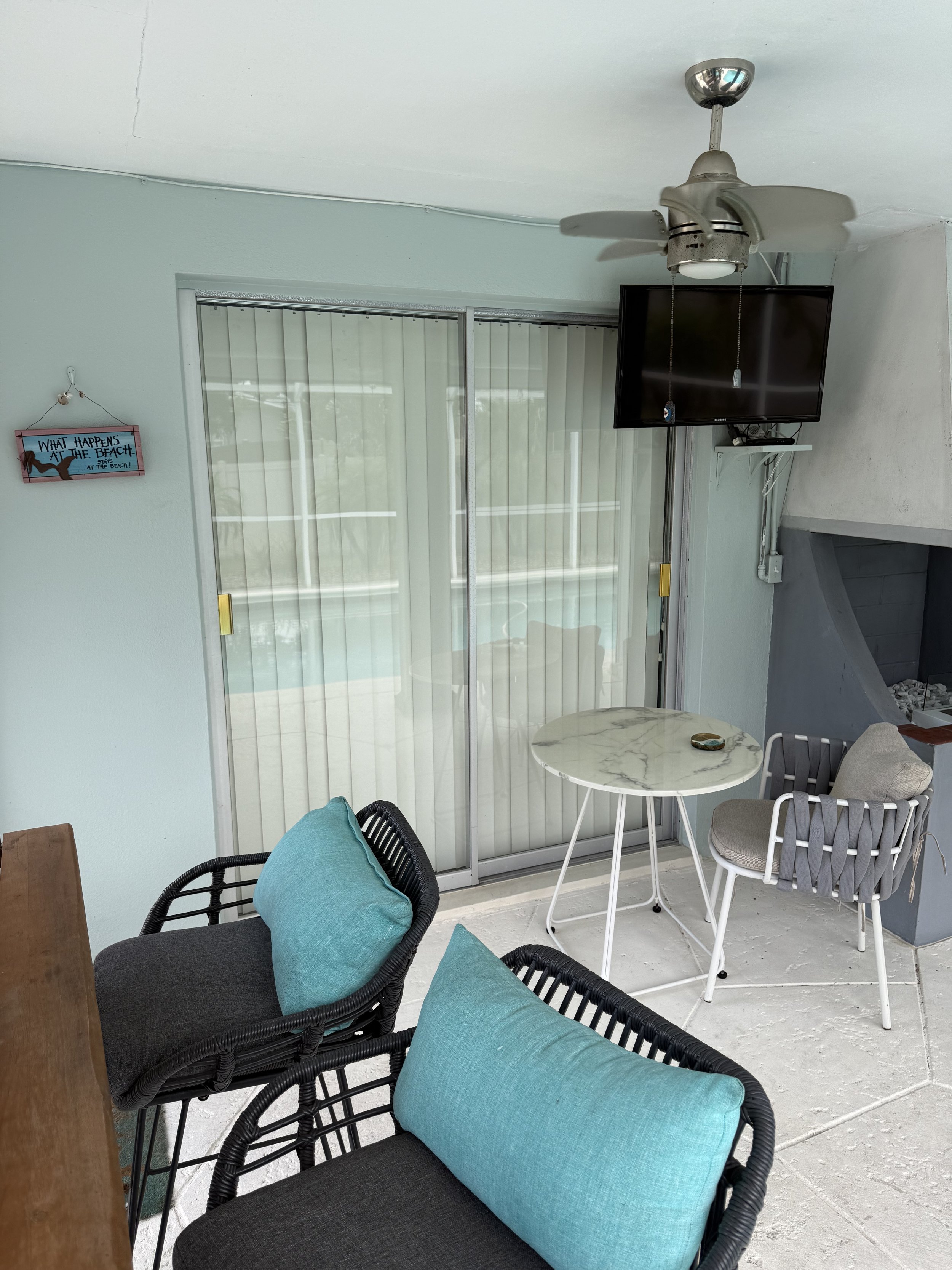 Sliding glass door with vertical blinds and pool reflection