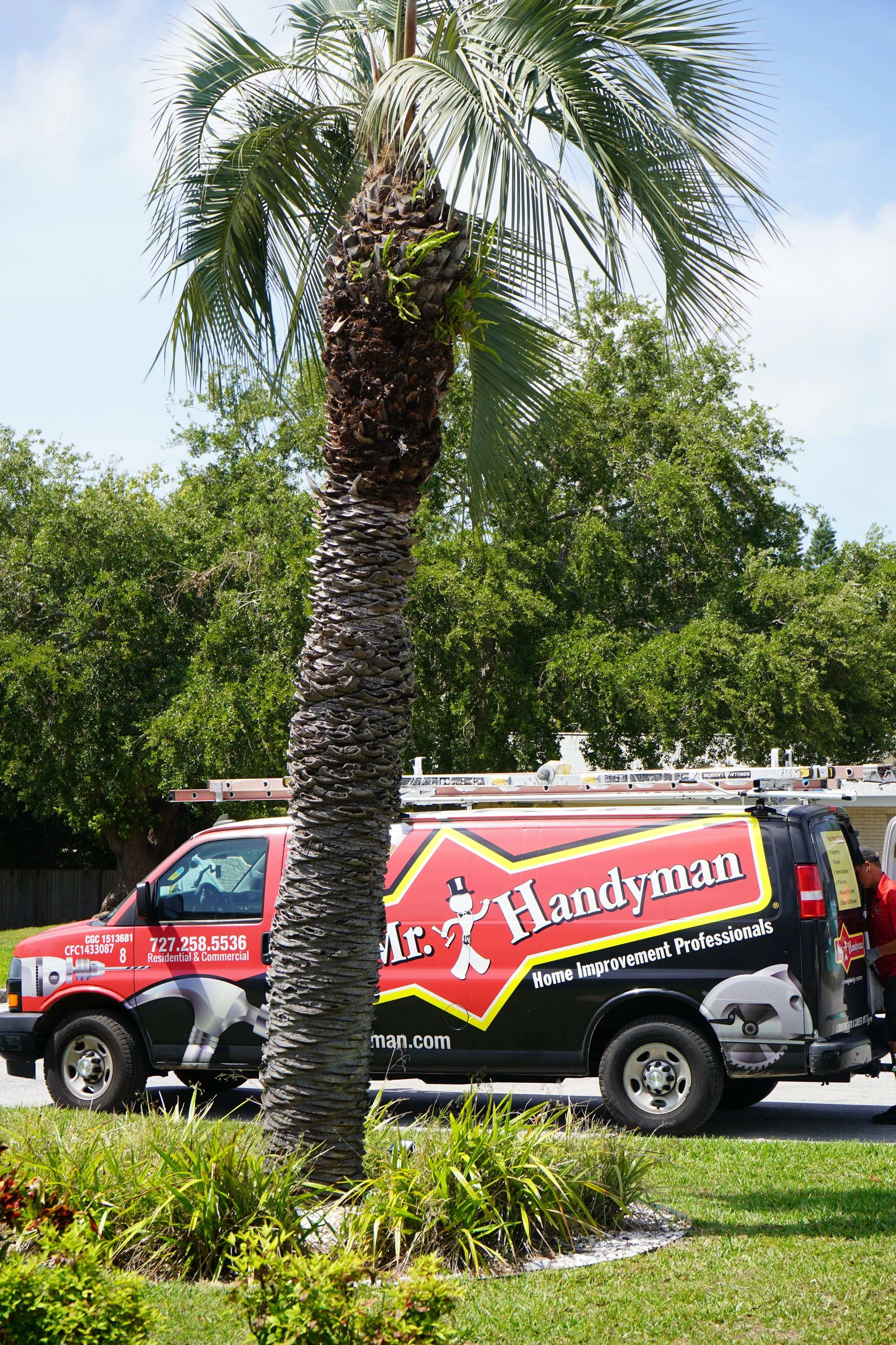 Mr. Handyman service van parked in a Florida neighborhood, ready for a job in Tampa Bay area.