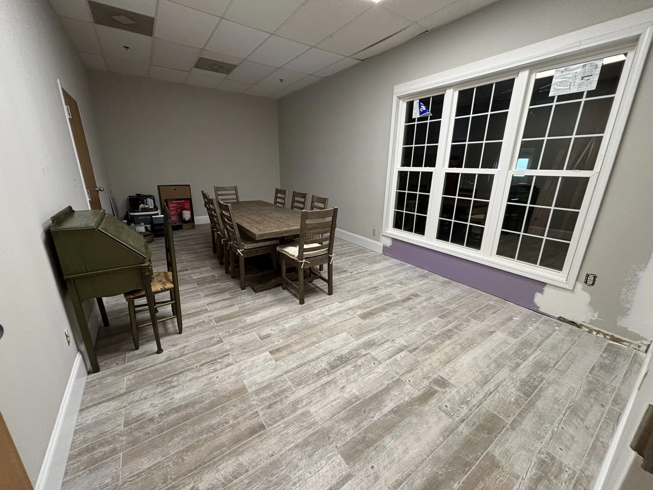 This conference room remodel included updated flooring, wall finishing, trim installation, and window framing. A great example of how we help commercial spaces feel modern, clean, and functional for everyday business use.
