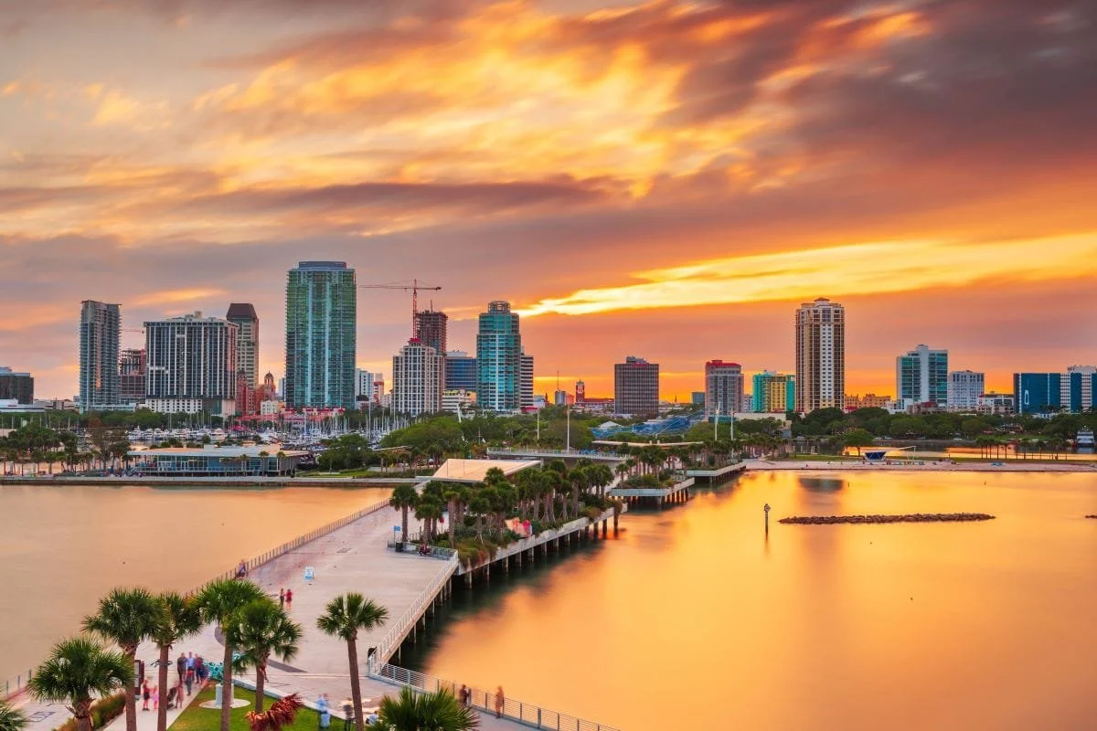 Downtown St. Petersburg skyline at sunset with waterfront views and vibrant skies