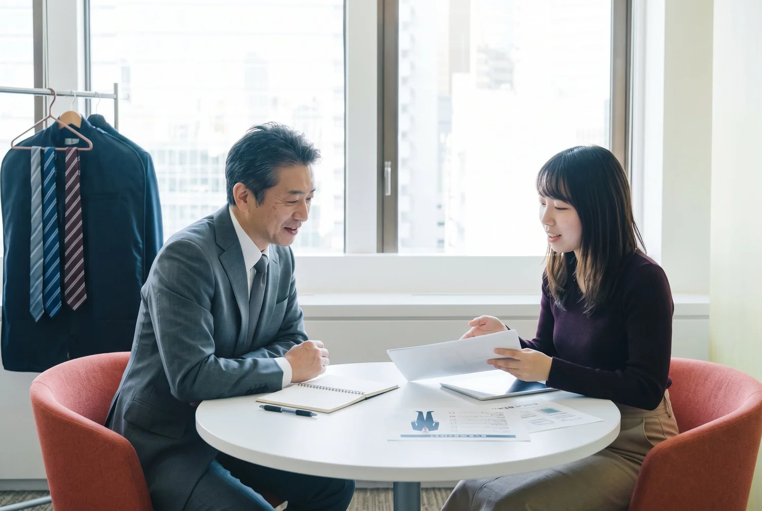 撮影当日の服装やネクタイについて役員に説明するご担当者