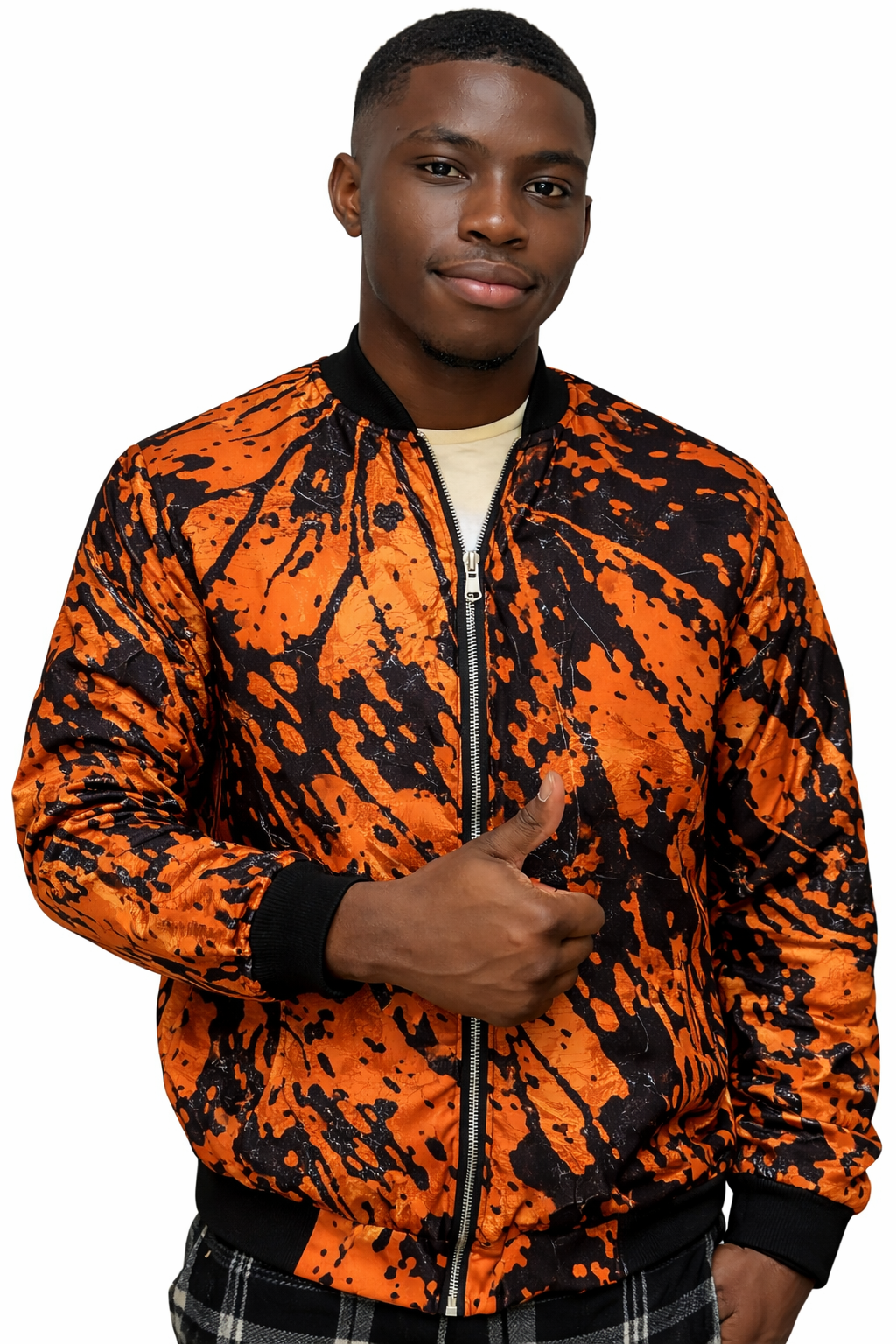 A young man with dark skin and short hair giving a thumbs-up gesture, wearing a vibrant orange and black splatter-pattern bomber jacket against a plain white background.