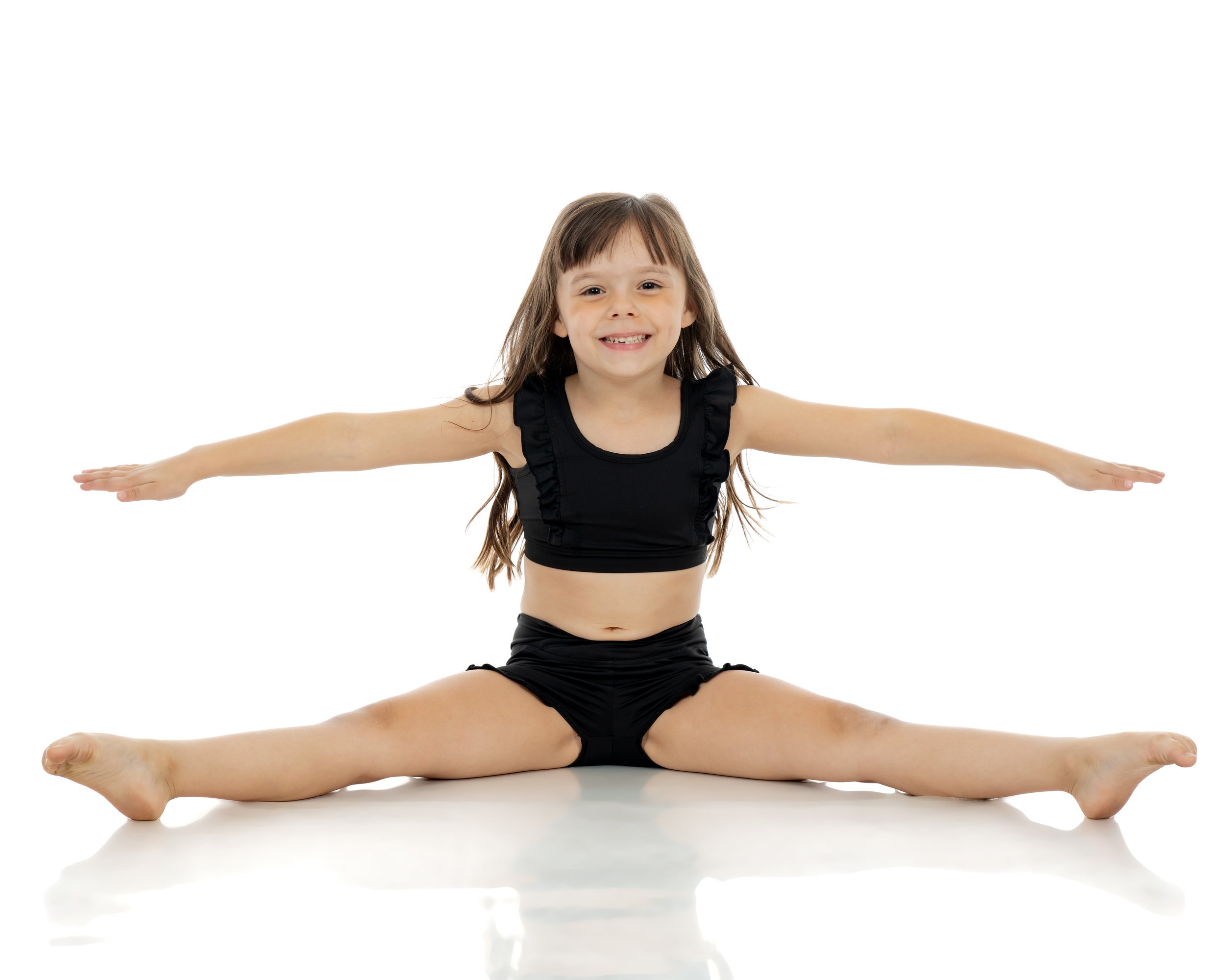 Young dancer smiling while performing a front split during class at NJ Dance To Inspire in Wyckoff, NJ.