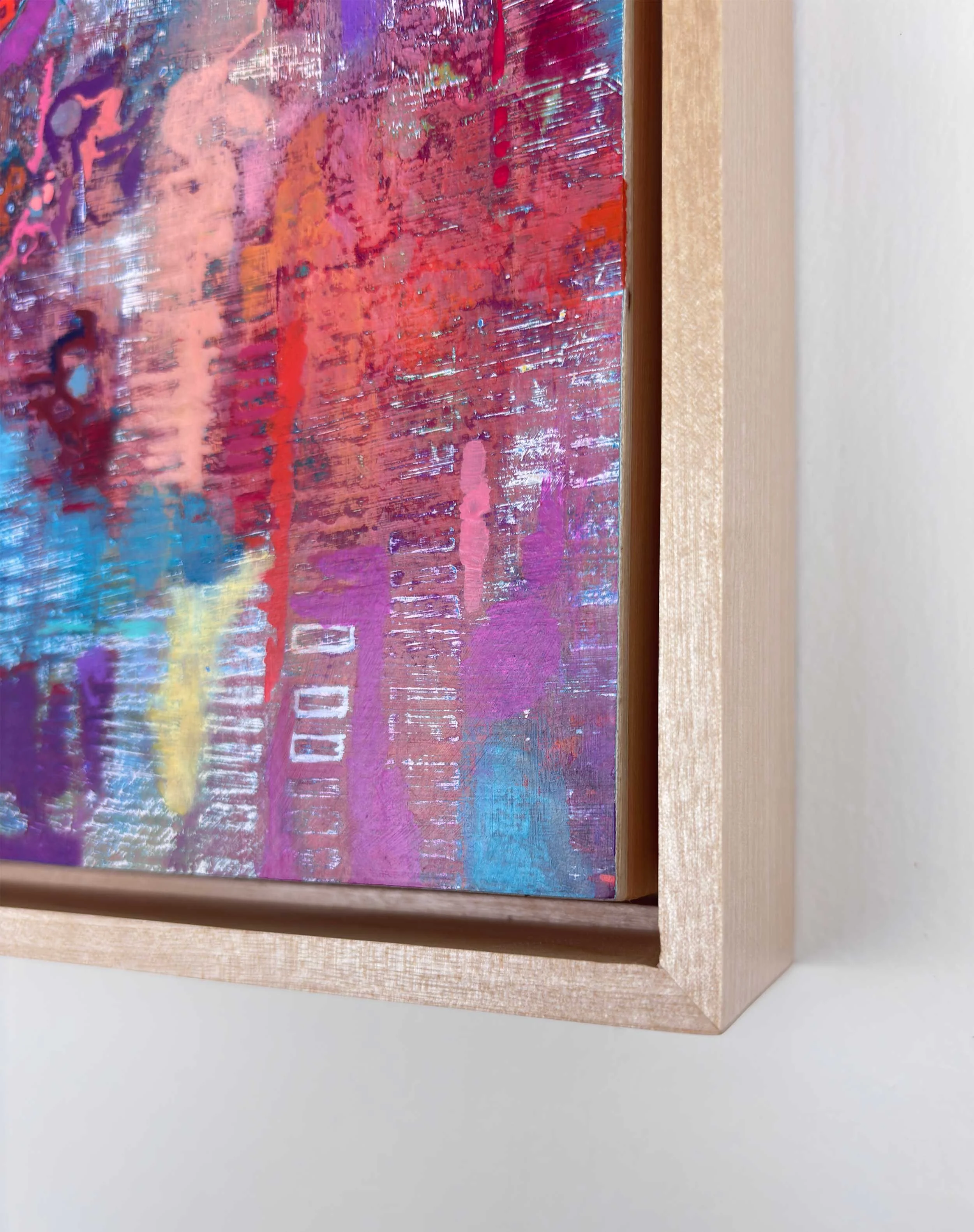Corner detail of “Radiant Trace” by Calie Durant, framed in light maple wood, showing surface texture and fine craftsmanship.