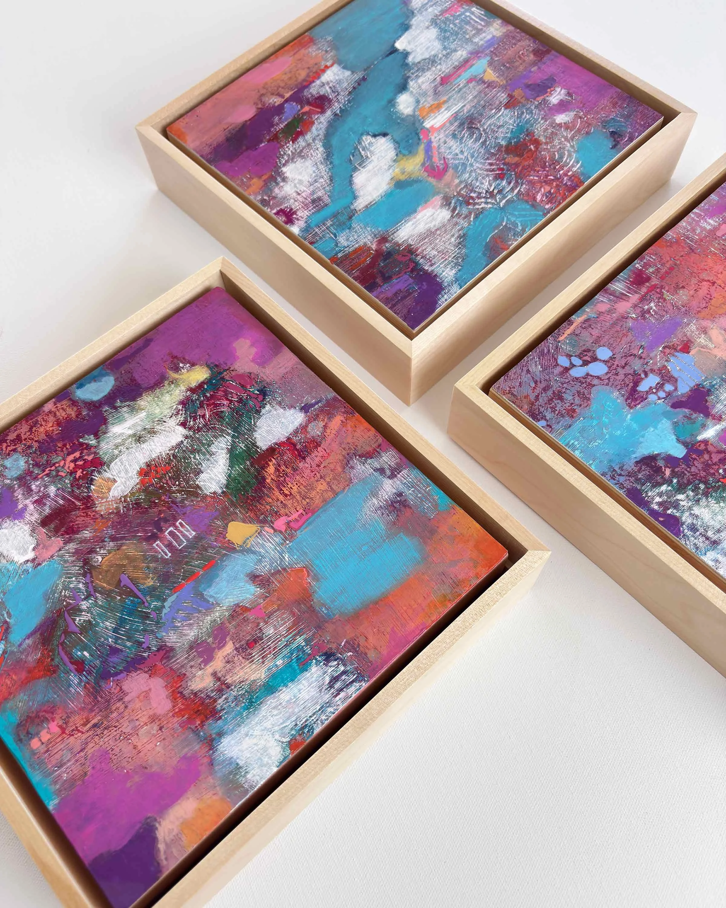 “Drift of Blue” by Calie Durant displayed as part of the Small Wonders series, shown alongside companion abstract paintings.