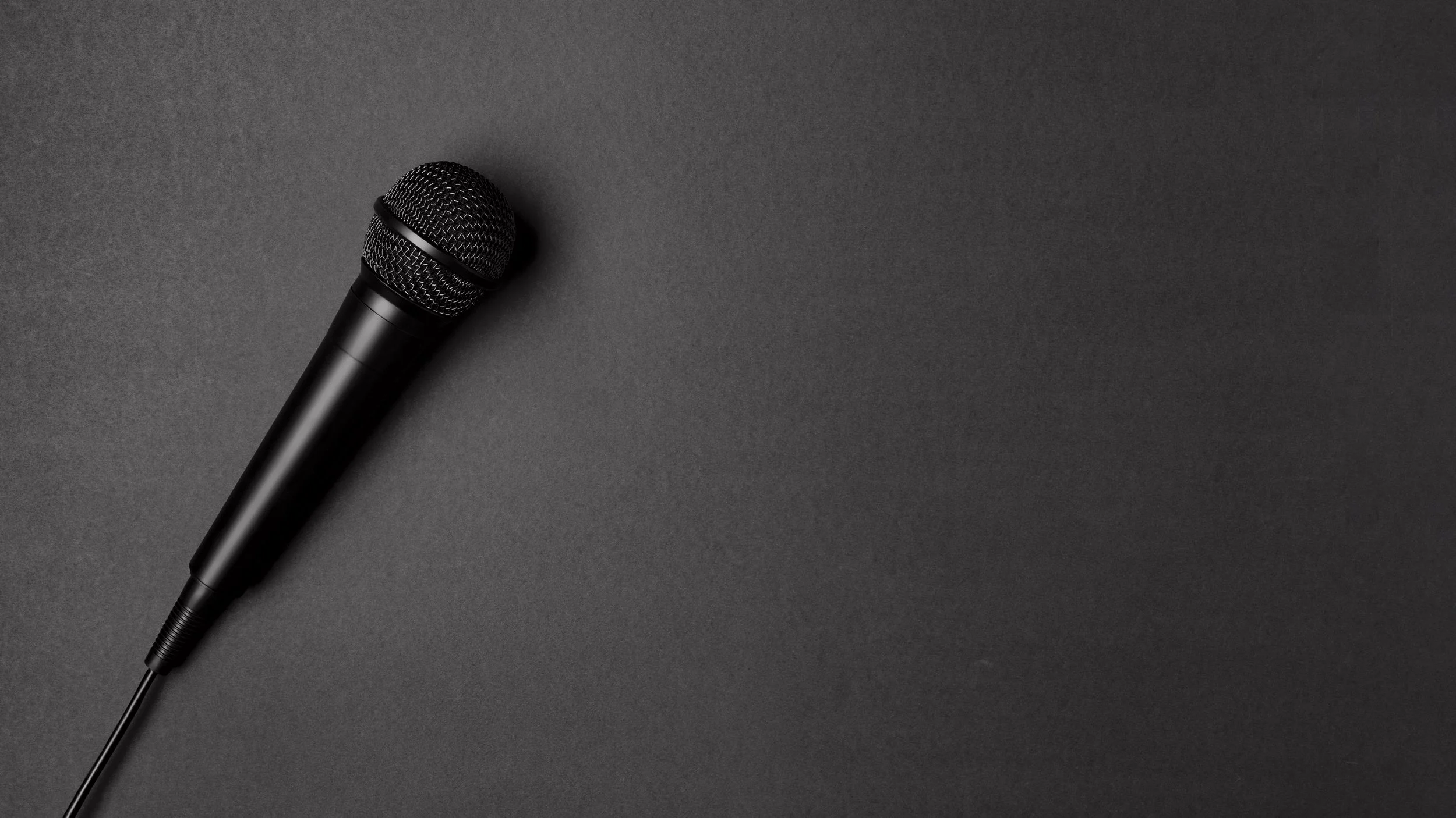 A black microphone on a dark gray surface.