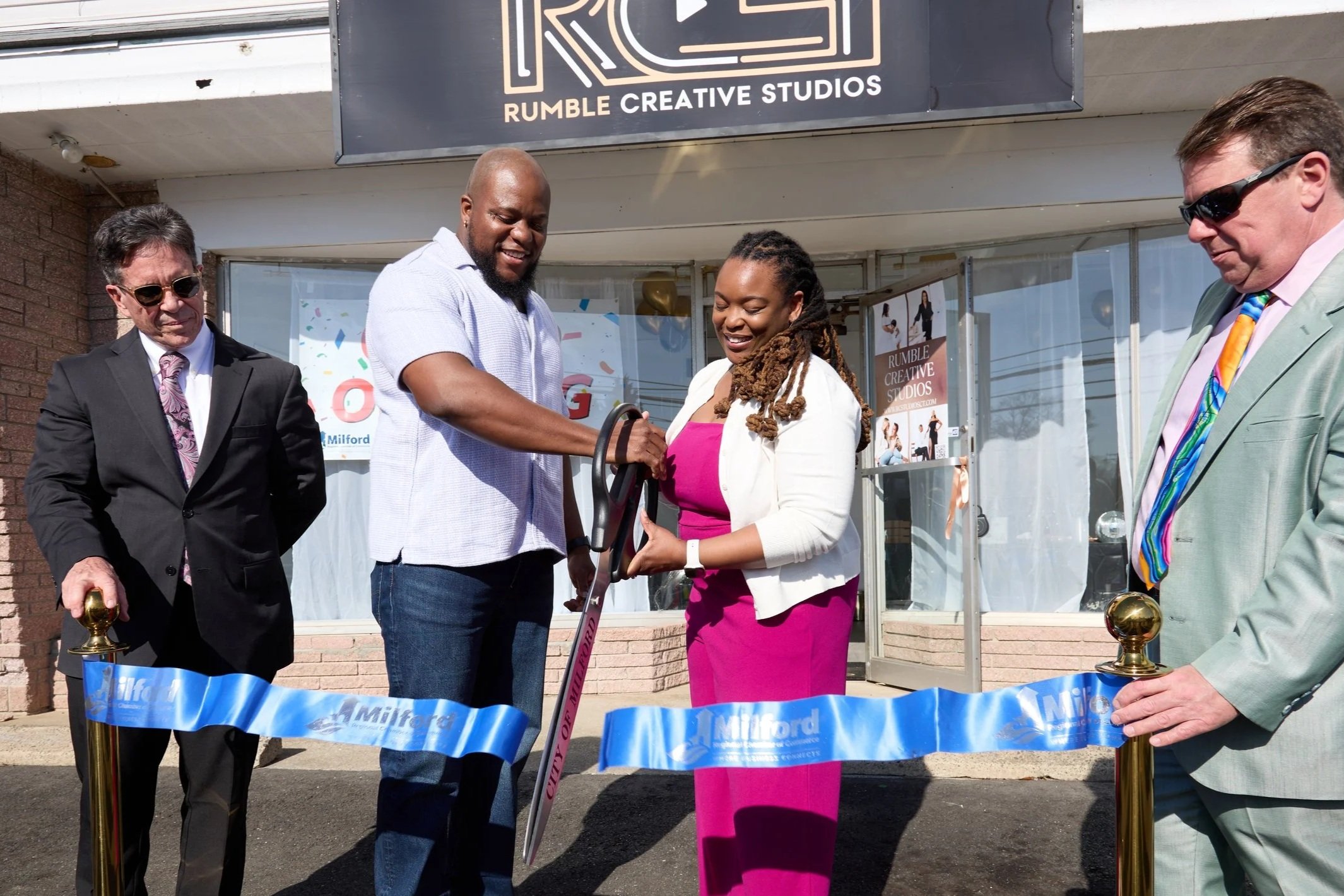 Karena Rumble-Carter and Brad Rumble cut the ribbon alongside Mayor Richard Smith and Simon McDonald of the Milford Chamber of Commerce in front of Rumble Creative Studios at 427 Naugatuck Ave in Milford, CT.