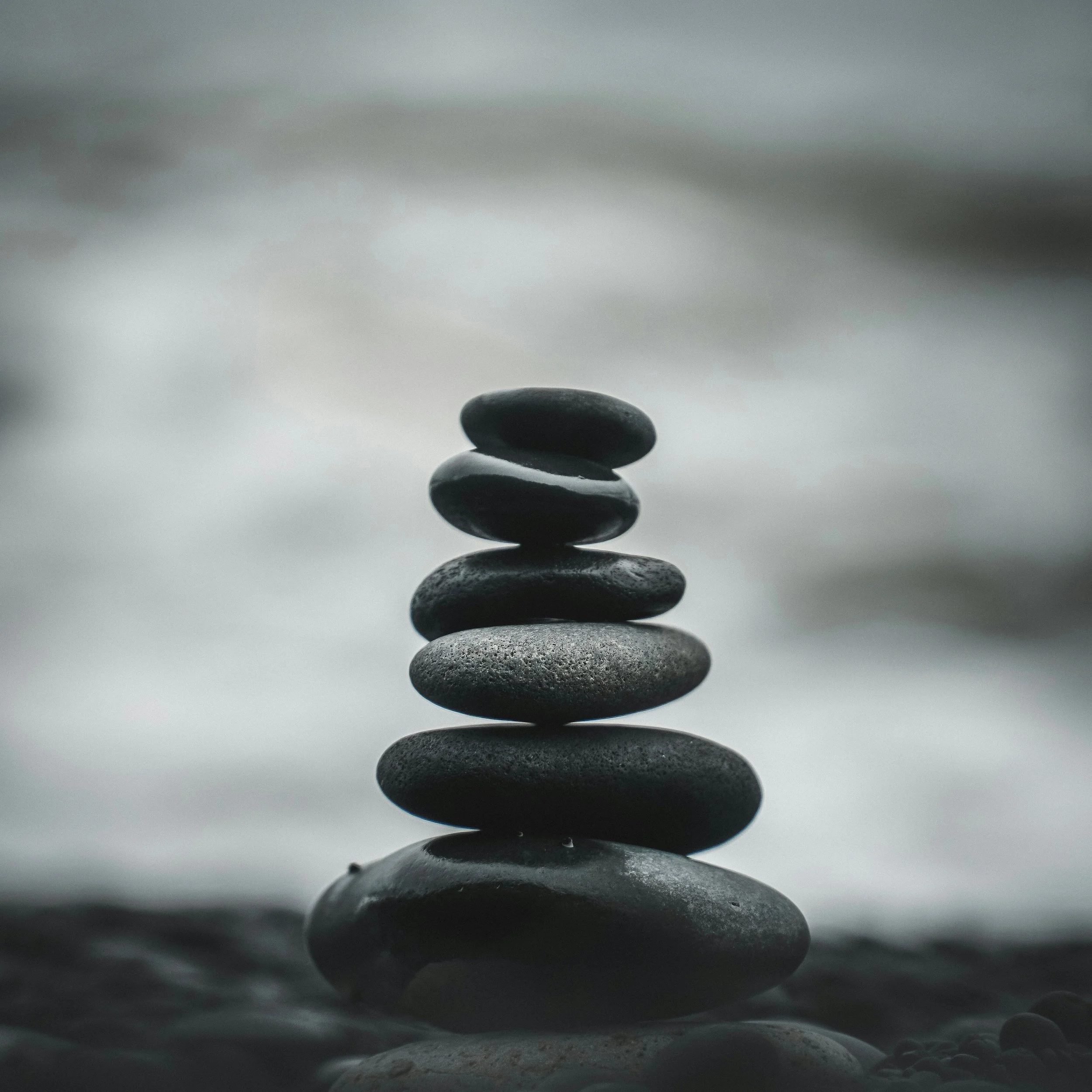 Stack of smooth dark stones balanced on top of each other.