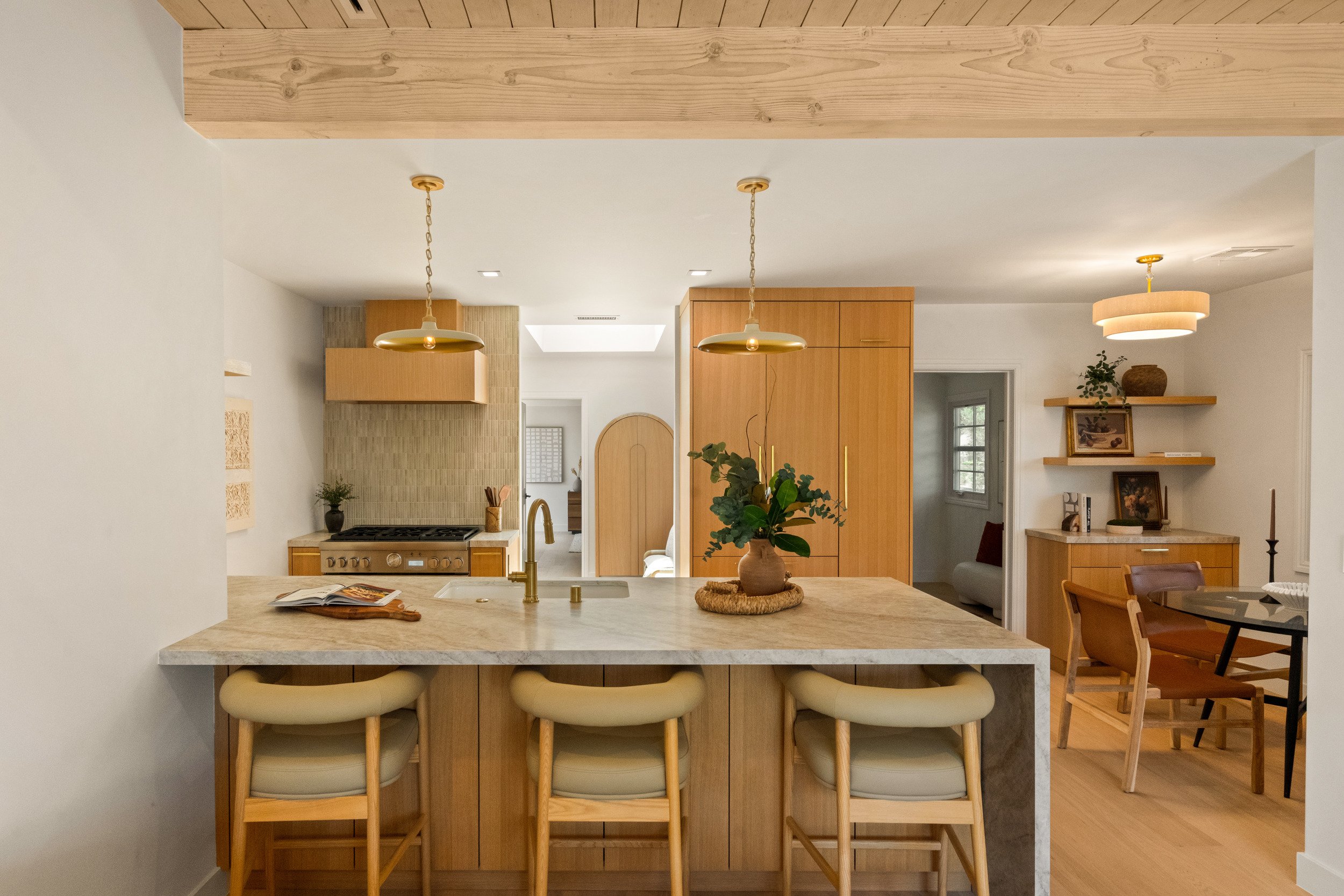 Kitchen with island seating and wood cabinetry.
