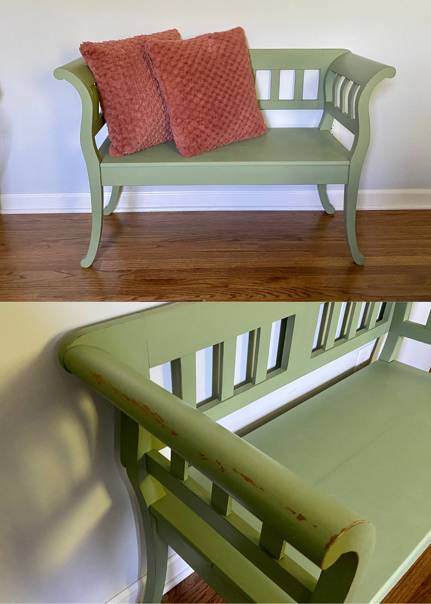 Green wooden bench with armrests and slatted backrest, placed against a white wall with two pink textured pillows on it, and a wooden floor underneath.