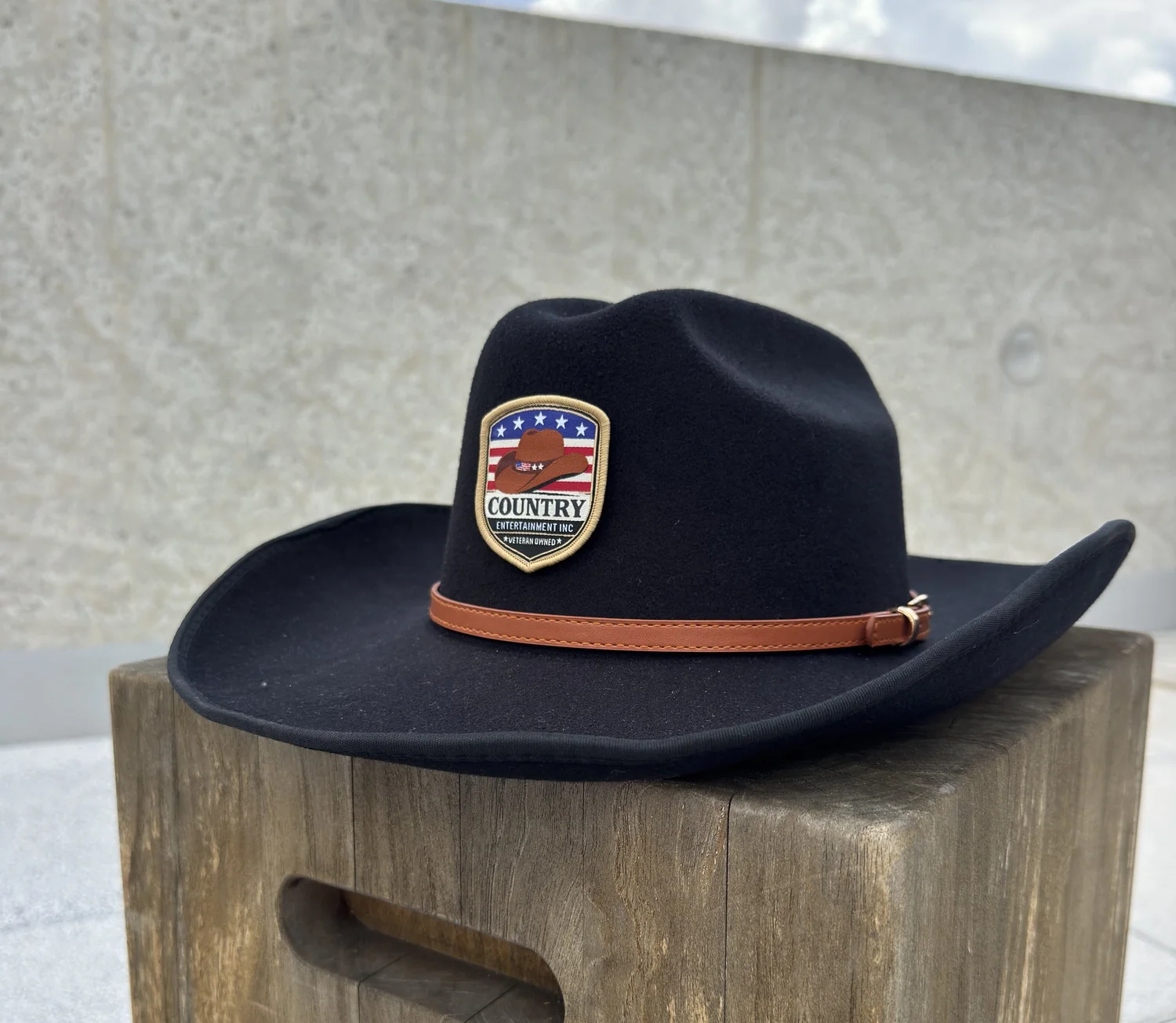 Colorful sublimation logo patch on a black Standard cowboy hat