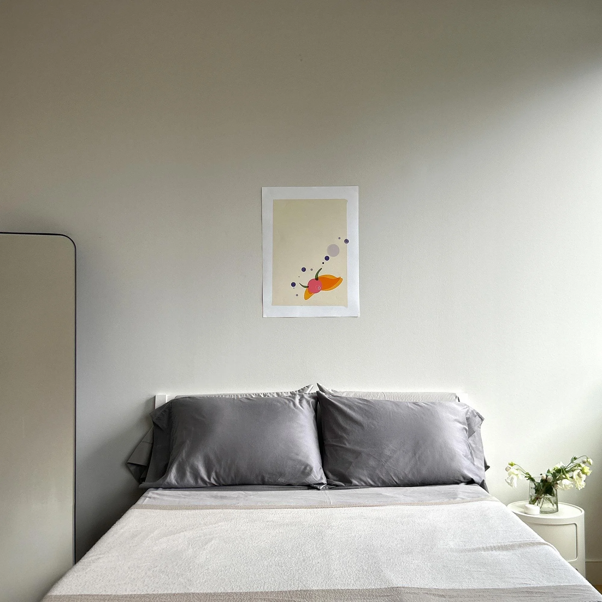 Snail Eye art print as bedroom statement piece, hung above bed. 18 x 14". From the Wanderer Collection