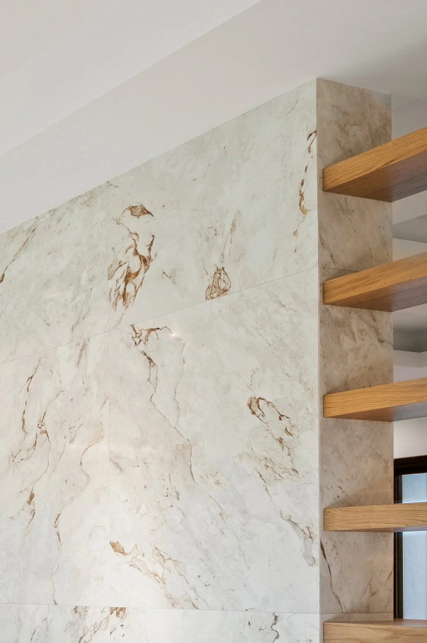 Elegant marble fireplace inlaid with custom wood shelving