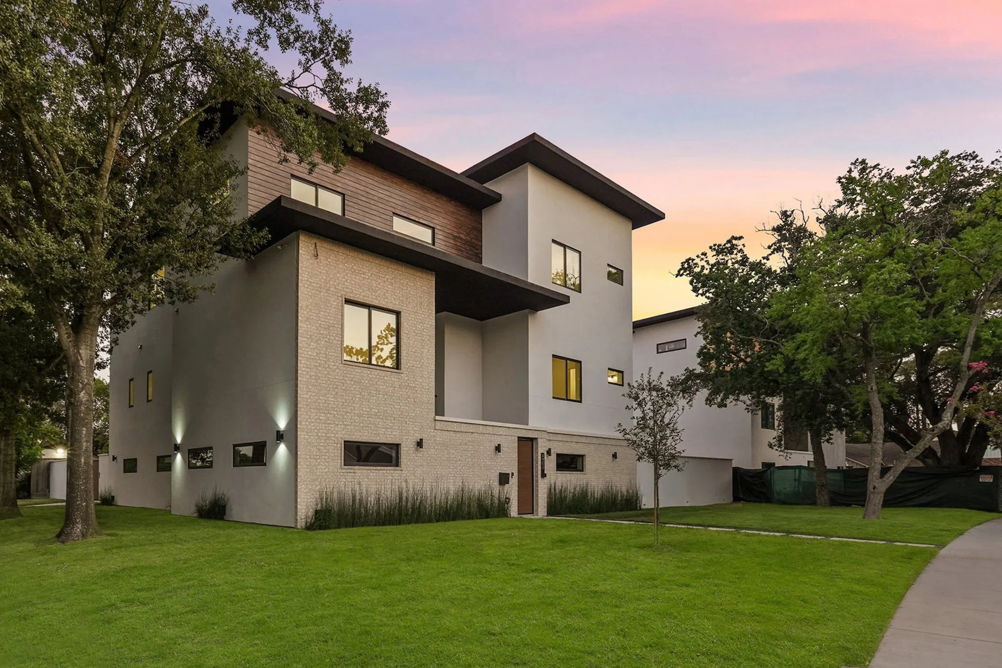 Three-story Everlasting Homes Building Group home in evening