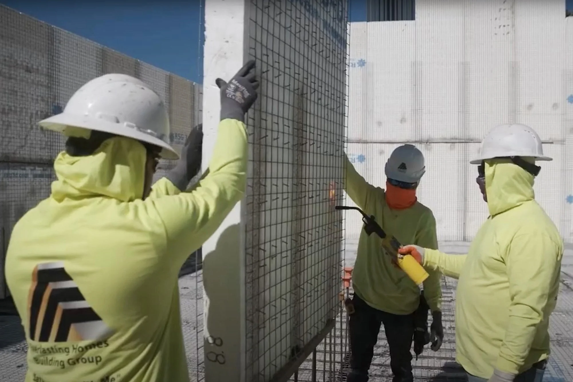 Crew on construction site building with Structural Concrete Insulated Panels (SCIP)