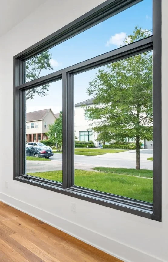 First floor window overlooking a yard and neighborhood.