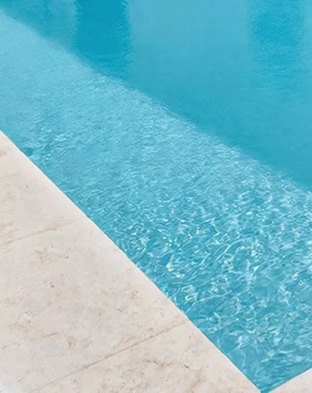 Edge of tile and shimmering pool water