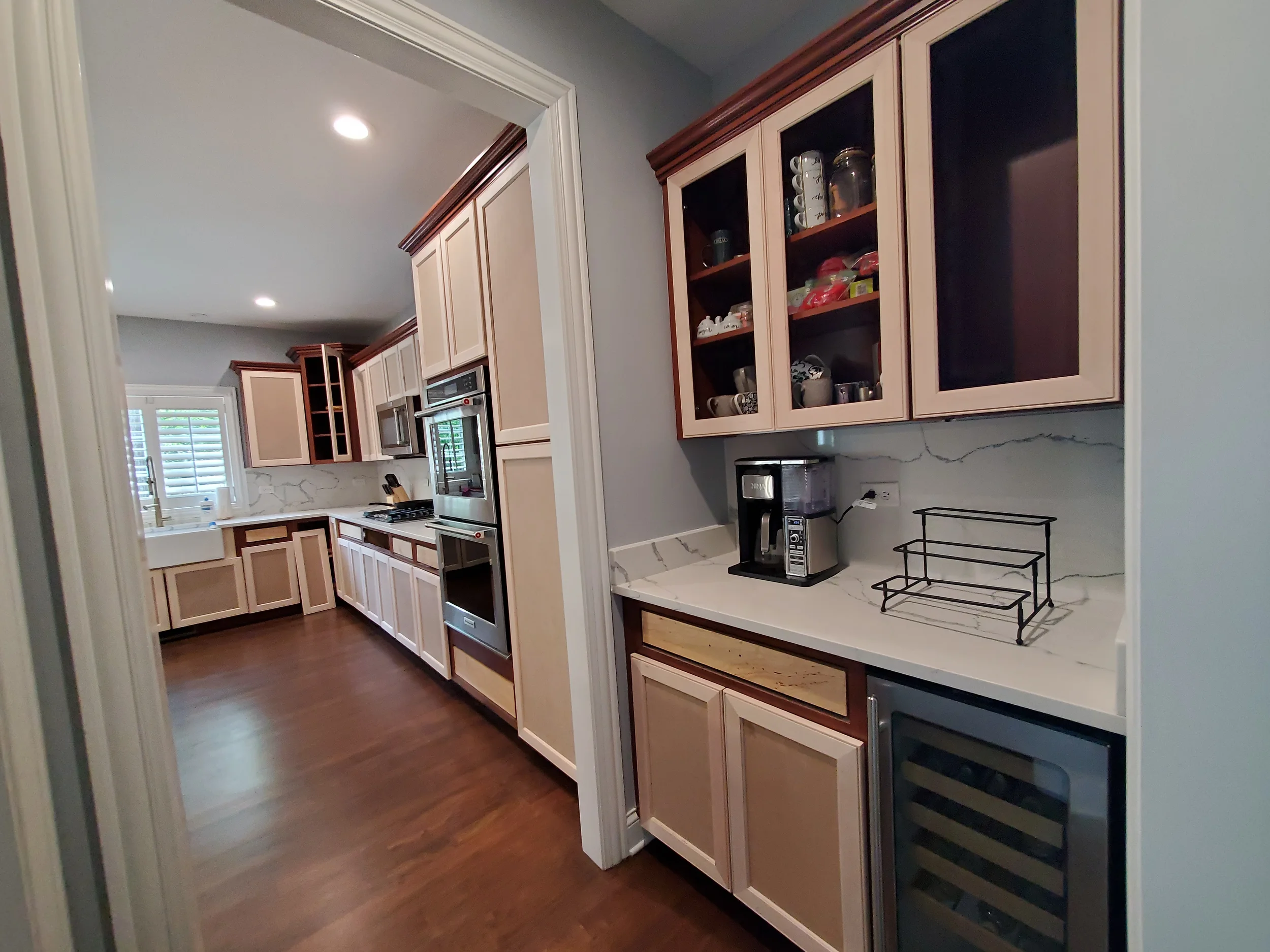 Dated dark wood kitchen cabinets in a Naperville home before Kora Pro Painting professional refinishing project.
