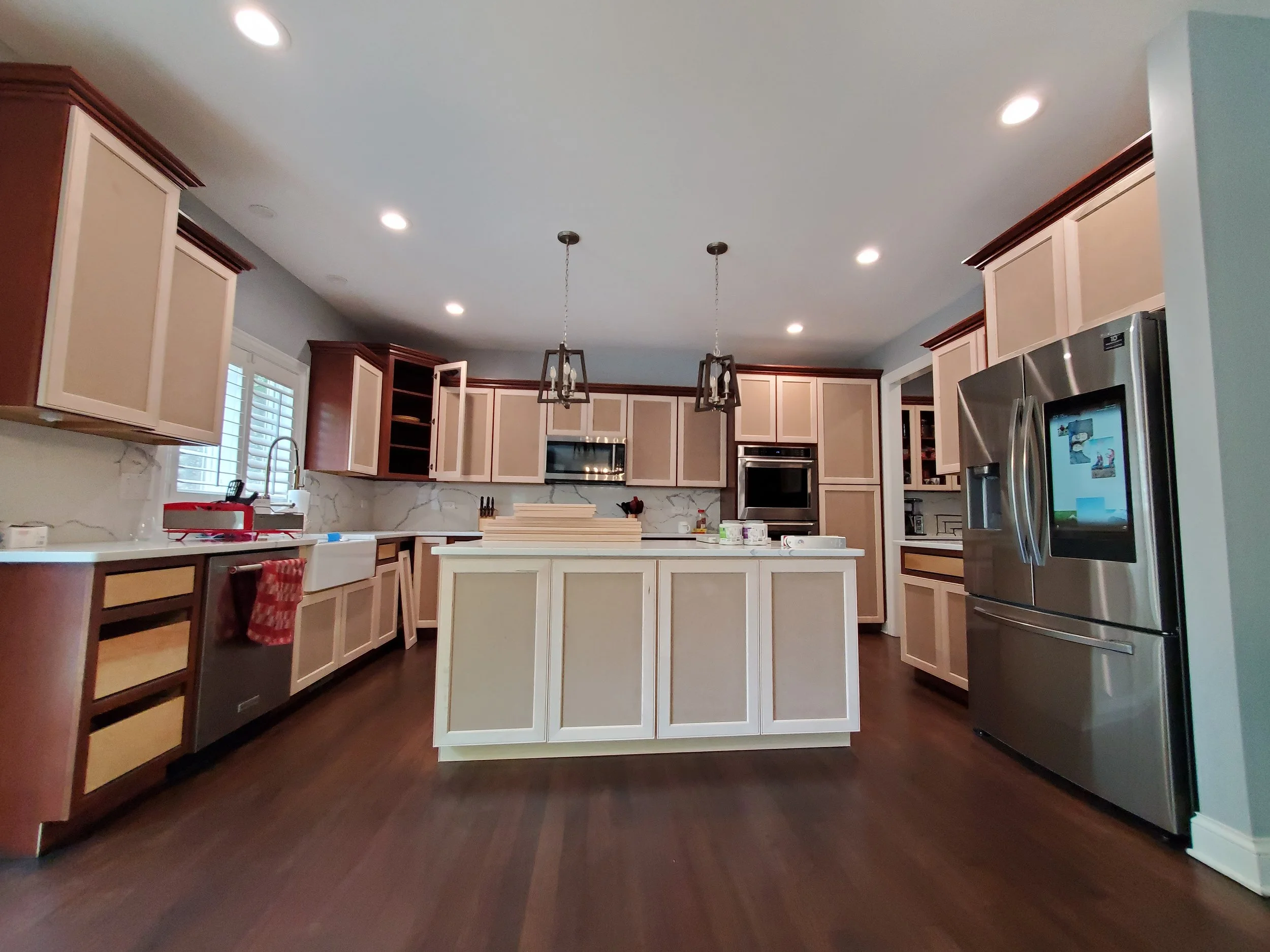 Dated kitchen cabinets with island prep work before professional refinishing in Naperville.