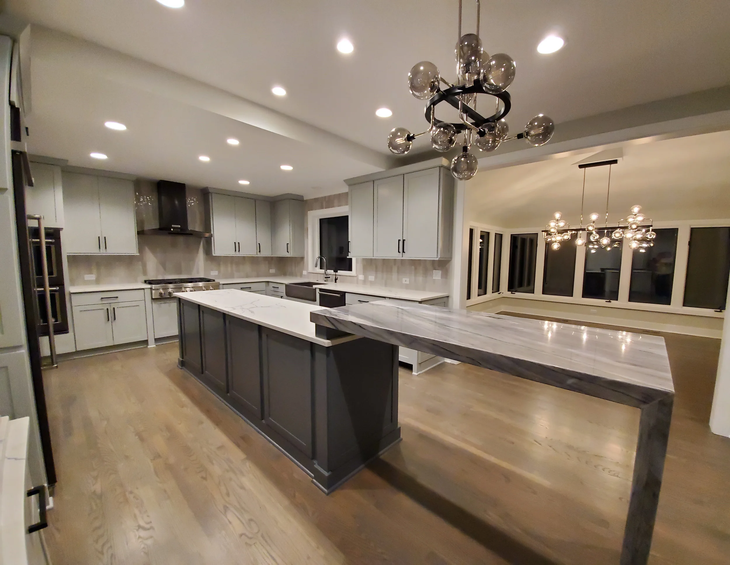 Professional kitchen cabinet refinishing in Barrington Hills featuring custom white cabinetry and a sophisticated dark tray ceiling transformation.