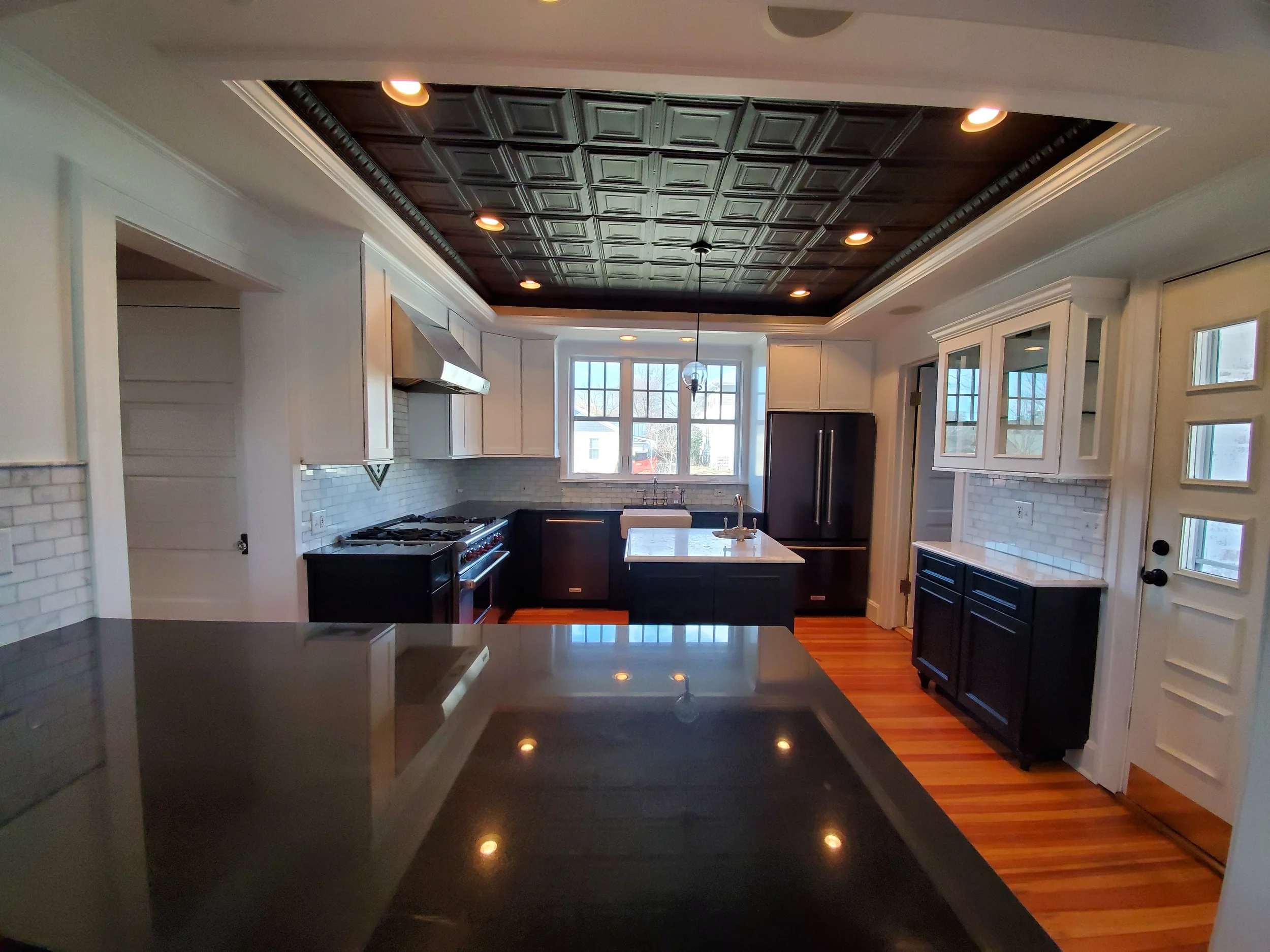 Factory-finish cabinet refinishing in a Wayne, IL luxury farmhouse. Transforming dated oak cabinets into a modern style with durable coatings.
