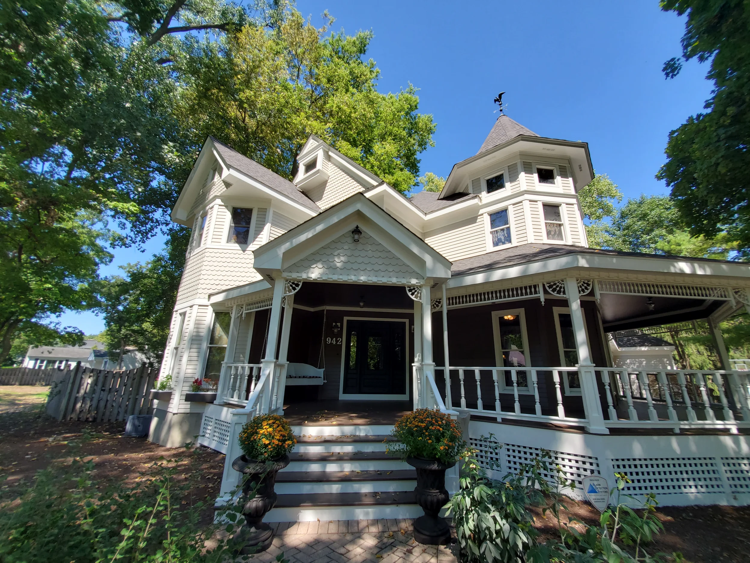 Exterior painting and restoration of a historic Victorian home in Geneva IL by Kora Pro Painting. Detailed trim and siding preservation.