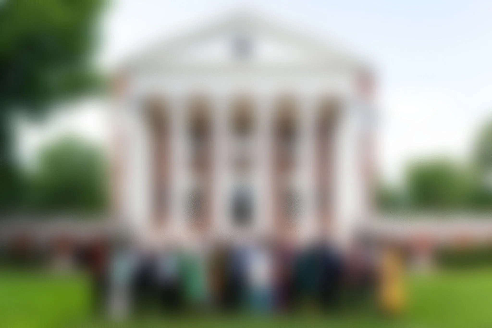 group of people standing in front of the UVA Rotunda