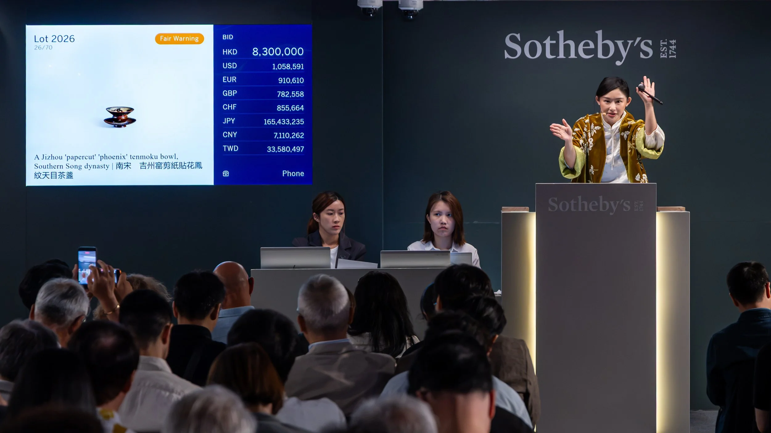 Sotheby's auctioneer CC Wang bringing the gavel down on the top lot of the auction— a Jizhou ‘papercut’ ‘phoenix’ tenmoku bowl, Southern Song dynasty —which sold for HK$10,624,000, setting a new auction record for Jizhou ware.