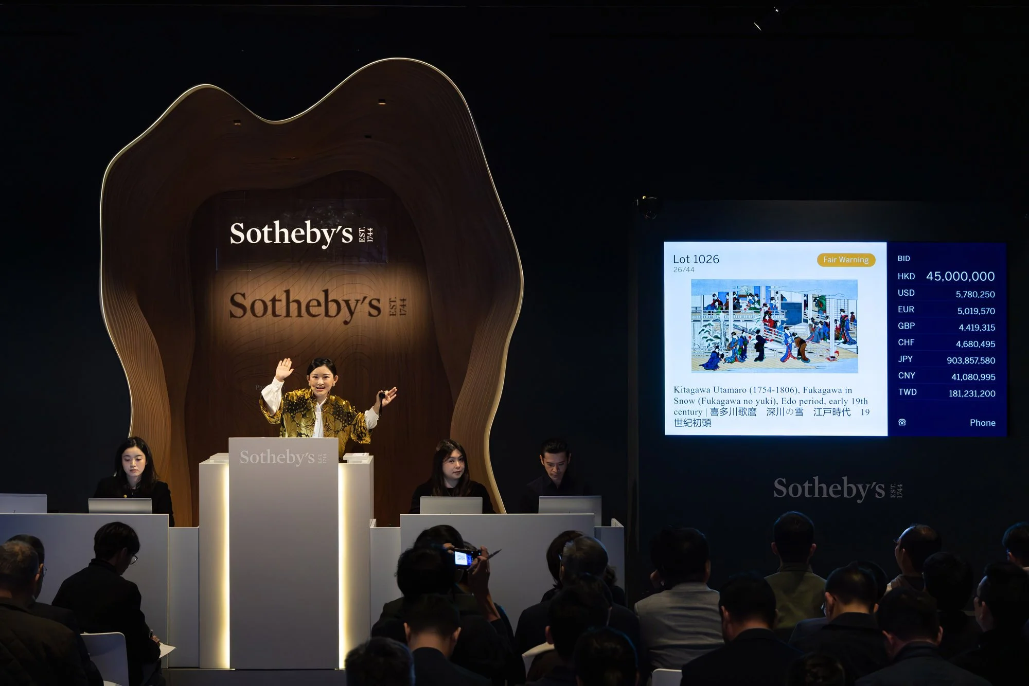 Auctioneer on the rostrum achieving an auction record for Japanese art