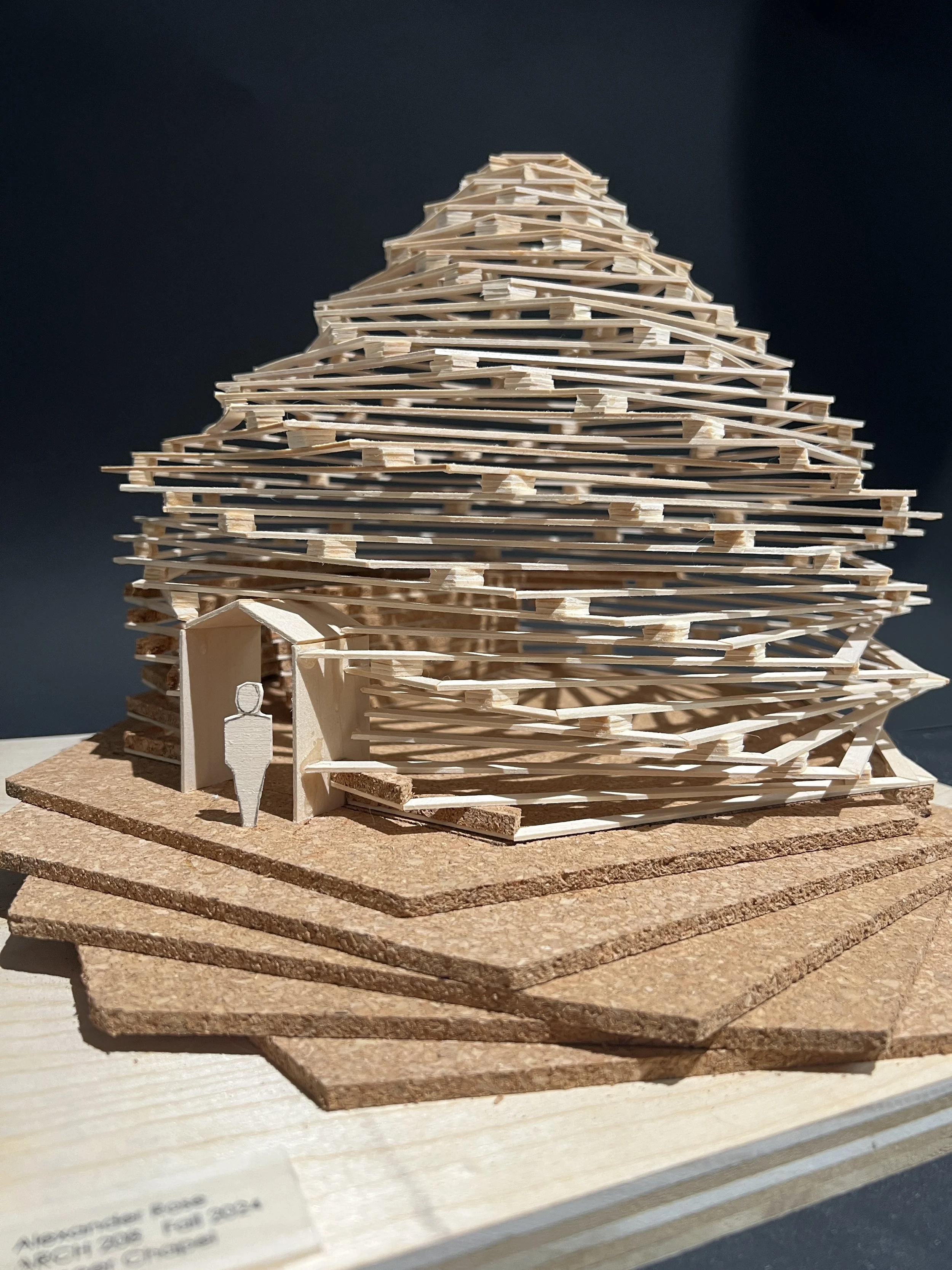 Physical architectural model exploring layered wooden slats and light-driven form, developed as part of an academic design studio project.