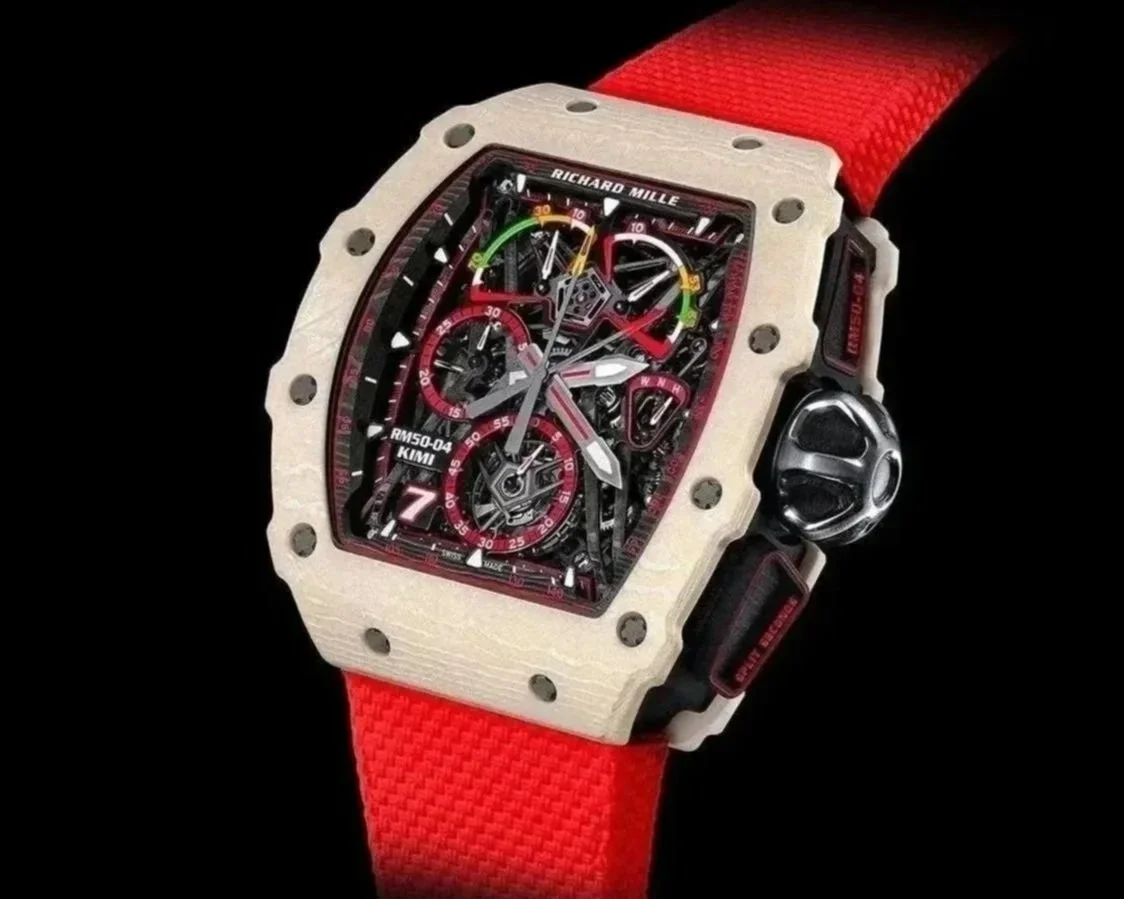 A luxury Richard Mille watch with a square-shaped case, red strap, and intricate skeleton dial showing gears and chronograph features.