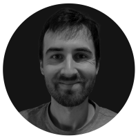 Black and white portrait of Justin Bunt, VFX Supervisor at LVL UP Digital, smiling in a studio-style headshot.