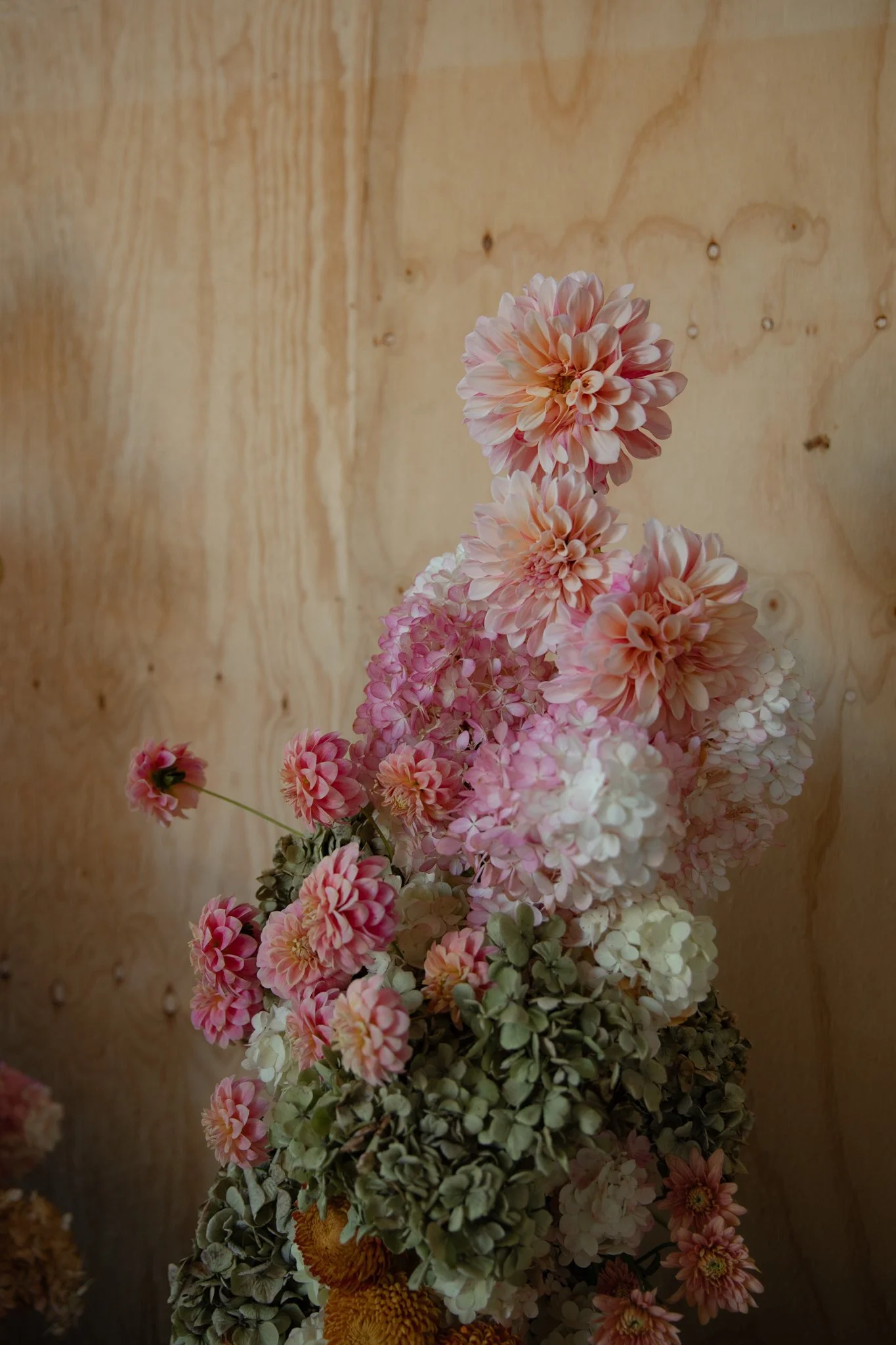 A beautiful large floral arrangement in pinks, creams and oranges.