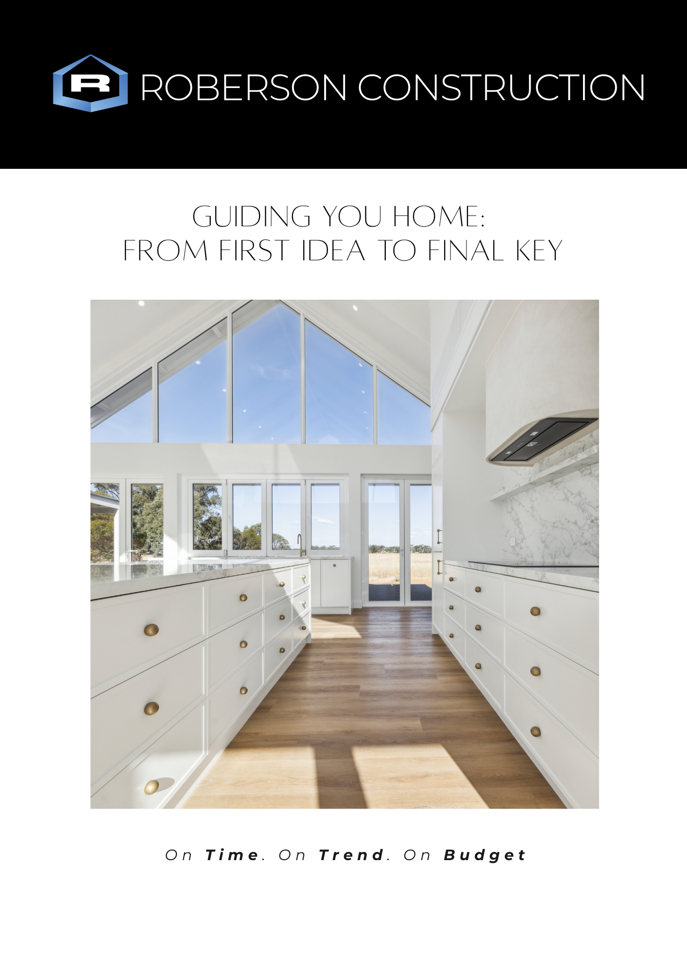 A modern kitchen with white cabinets, gold knobs, hardwood floors, large windows, and a skylight, with text overlay about home building guidance.