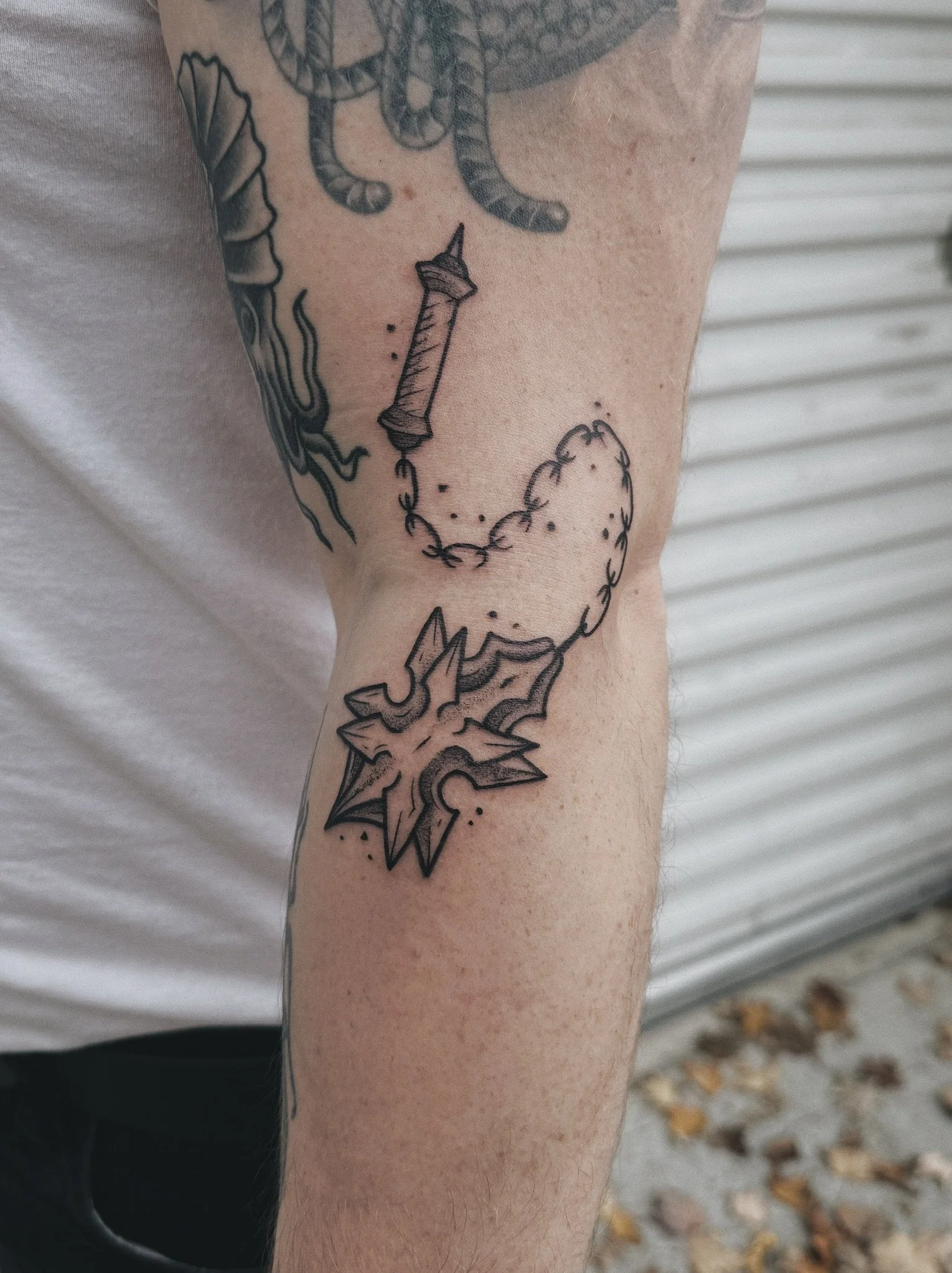 linocut inkblot medieval blackwork linework tattoo of a flail, witch kings flail mace from lord of the rings